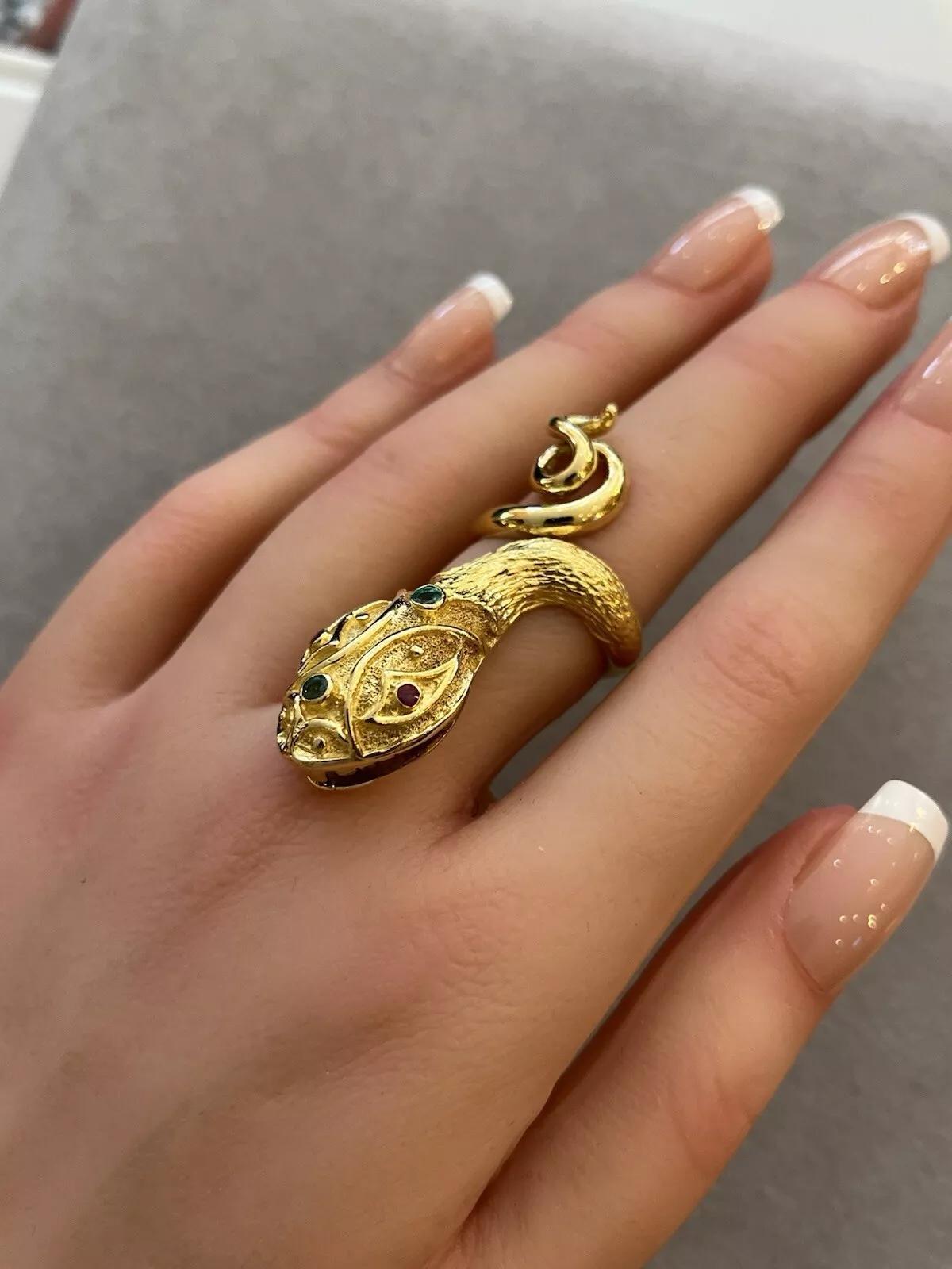 Lalaounis Snake Ring with Ruby and Emeralds in 18k Yellow Gold 

Lalaounis Snake Ring features a Large Headed Snake with Emeralds and Rubies set in an 18k Yellow Gold Textured body with a High polished tail.

Ring size is 6.75
Ring measures 1.85