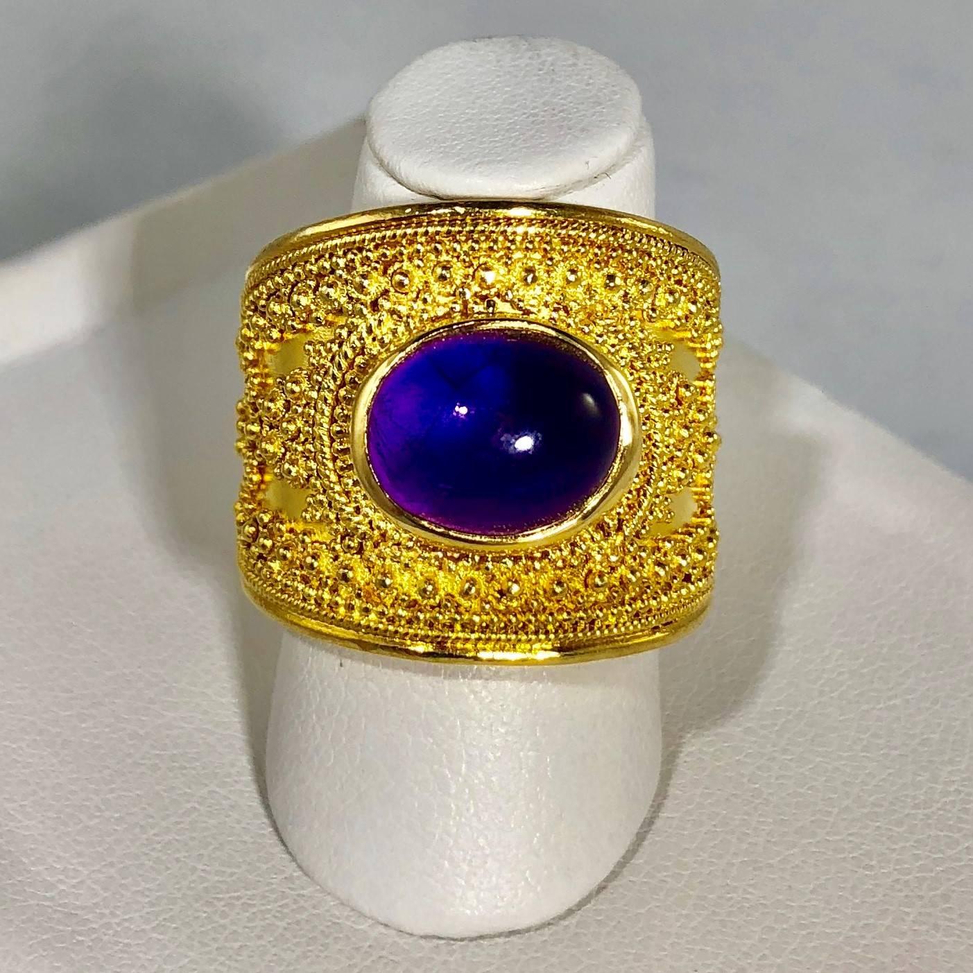 Lalaounis 18 karat Cabochon Amethyst vintage cocktail ring. This stunning piece is a Llias Lalaouis original created in Etruscan style, 18 karat yellow gold- weight 19.8 grams, 12.8 Dwt.. The center stone is a Cabochon cut Amethyst, approx. 2.5