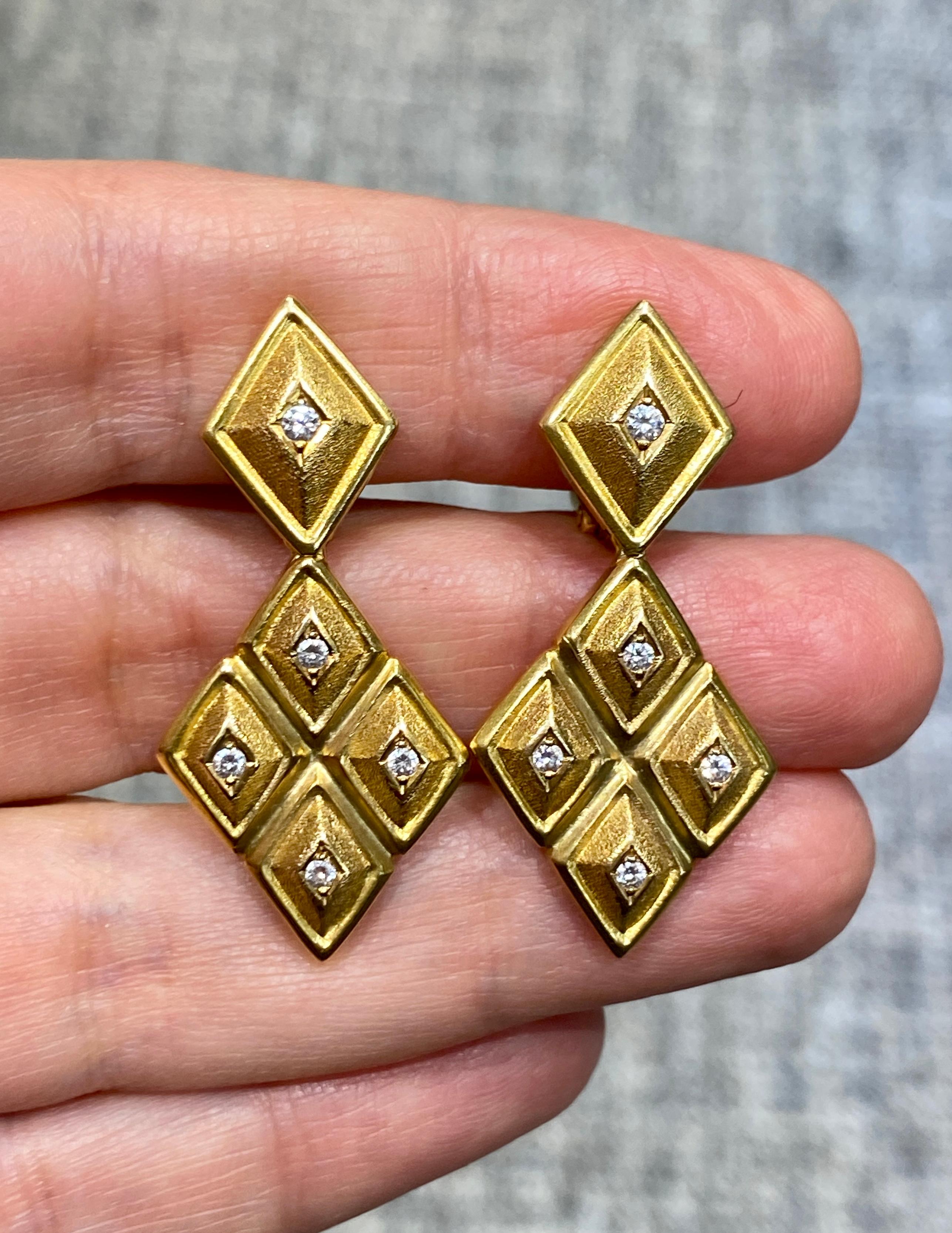 These striking Lalaounis earrings are made of 18k yellow gold and are adorned with small round cut diamonds. They are originally clip-on but a pin can easily be added for extra safety. Although chunky in appearance they are comfortable to wear.