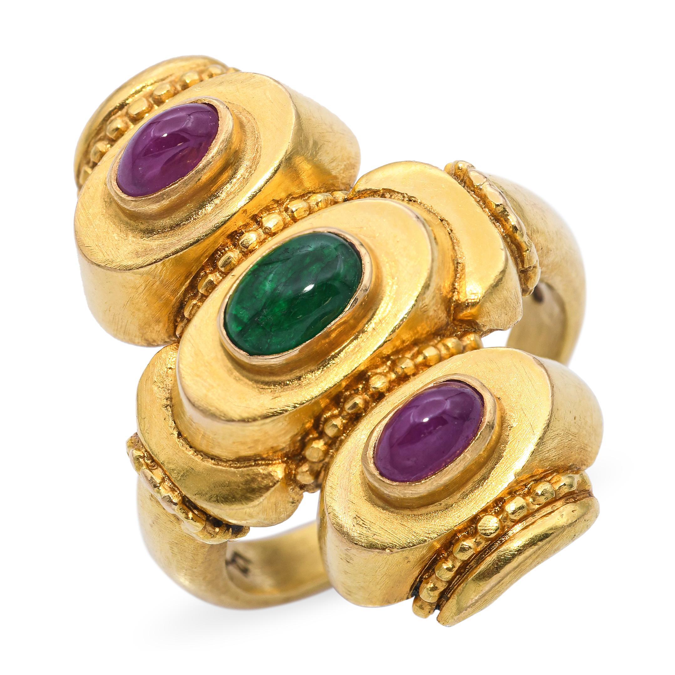 This Ilias Lalaounis ring exemplifies the designer's mastery in blending ancient motifs with luxurious materials. Crafted in 18k yellow gold, the ring showcases a Greek-inspired design adorned with vibrant rubies and emeralds. The intricate goldwork