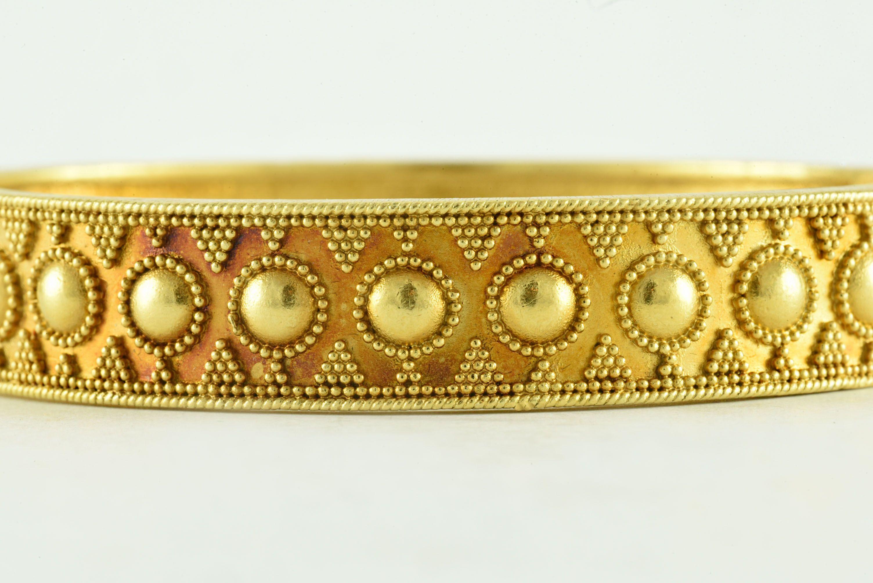 This 18kt yellow gold bangle bracelet was designed by the celebrated Greek jeweler, Ilias Lalaounis.  
