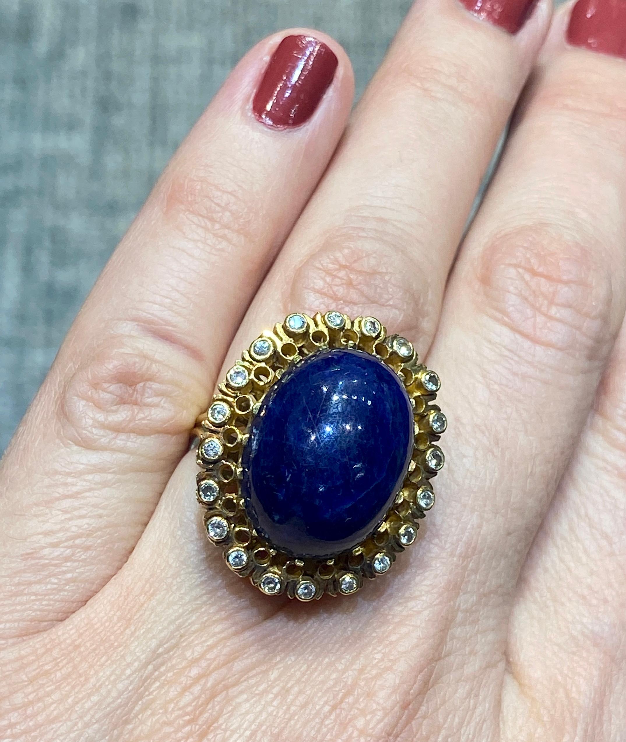 This beautiful 18k gold Lalaounis cocktail ring consists of a large cabochon lapis lazuli surrounded by small round cut diamonds. The ring is a part of a set with a pair of earrings pictured below and listed separately on 1st Dibs