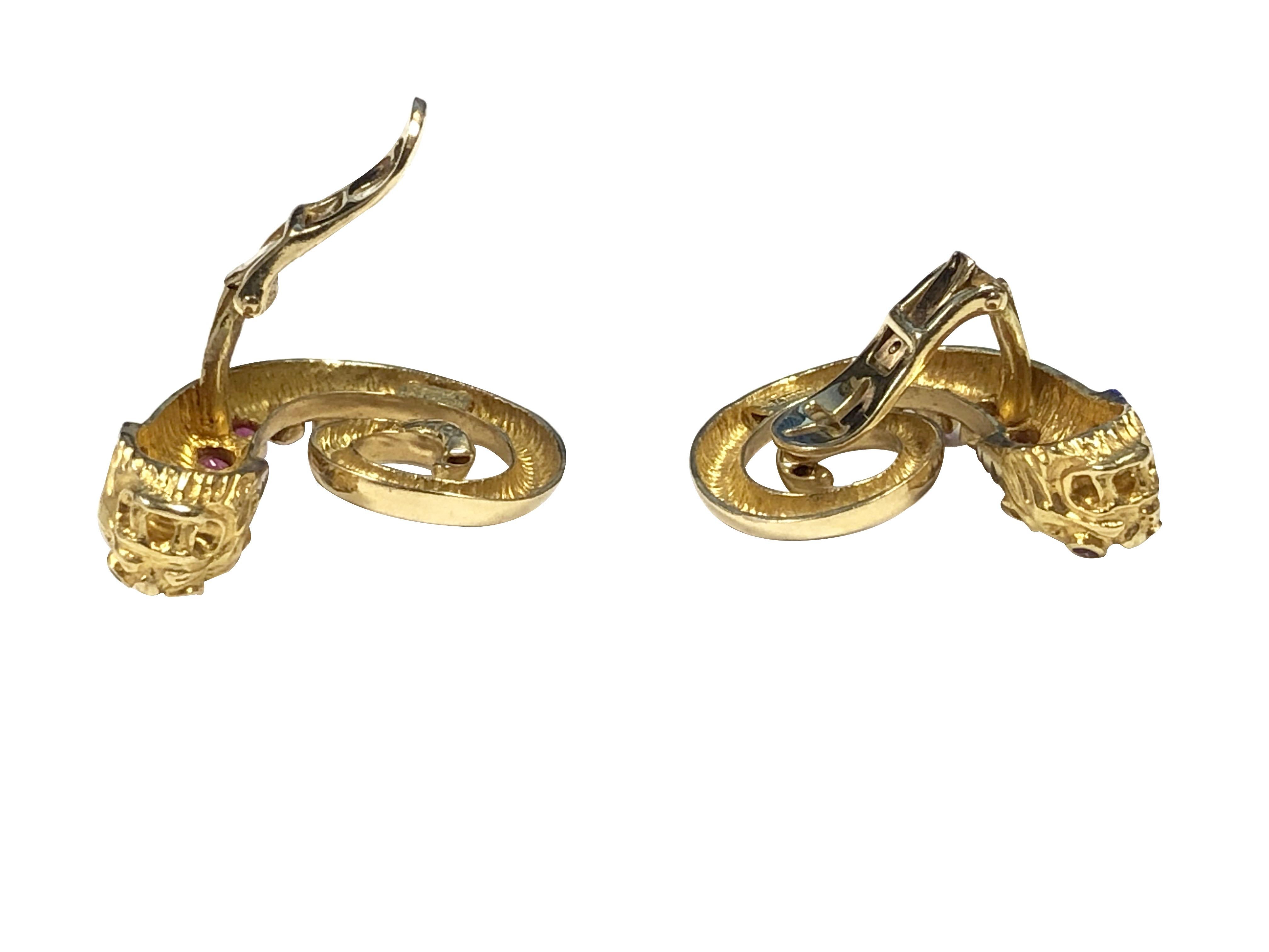 Circa 1980s Ilias Lalaounis 18K Yellow Gold Chimera Head Earrings, measuring 1 1/4 X 1 inch, finely detailed and set with Rubies and Diamonds. Clip backs to which a post can be easily added if desired. 