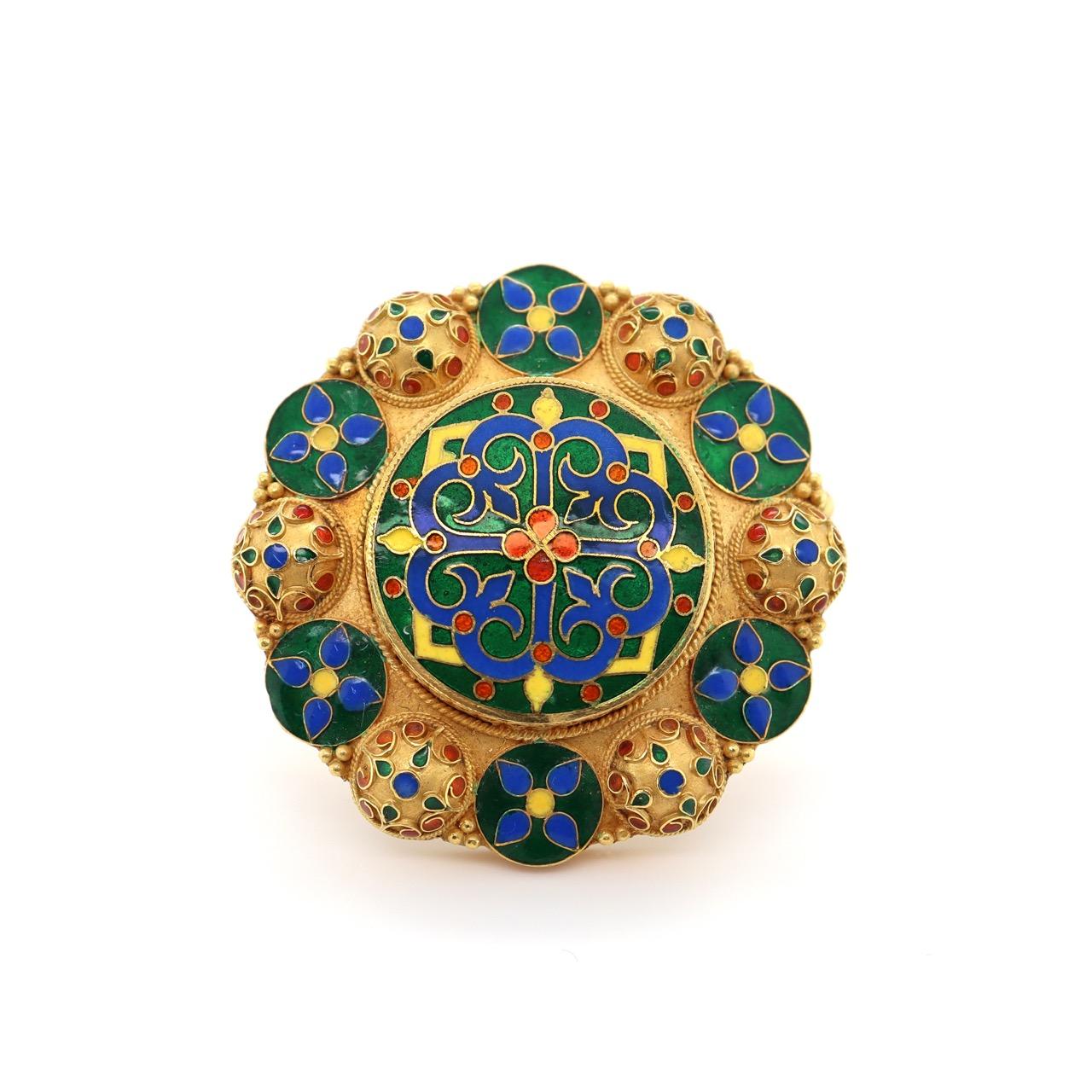 Lalaounis Cross Mandala Brooch, ca. 1950s/1960s

An early brooch from the Greek designer Ilias Lalaounis, depicting a cross in the centre in multi-coloured enamel work, surrounded by Mandala like domes and circles. This brooch shows beautifully the