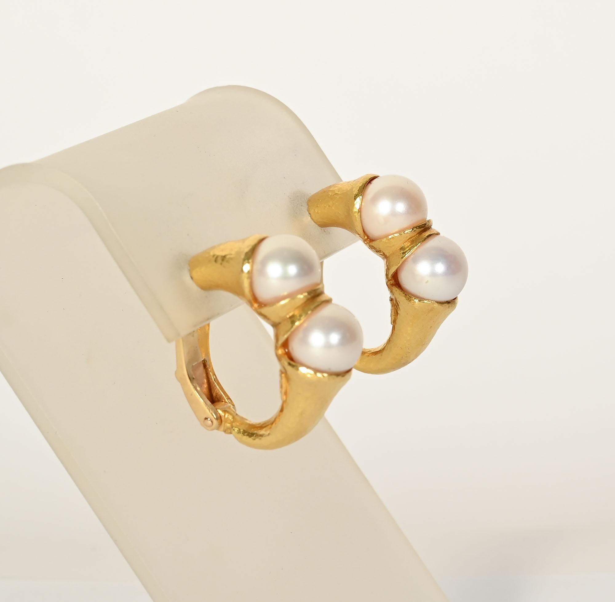 Half hoop gold and pearl earrings by famed Greek designer, ilias Lalaounis. Each earring has two pearls approximately 9 mm in size. The 18 karat gold has the finely hammered finish often used by Lalaounis. The earrings are one inch in both length