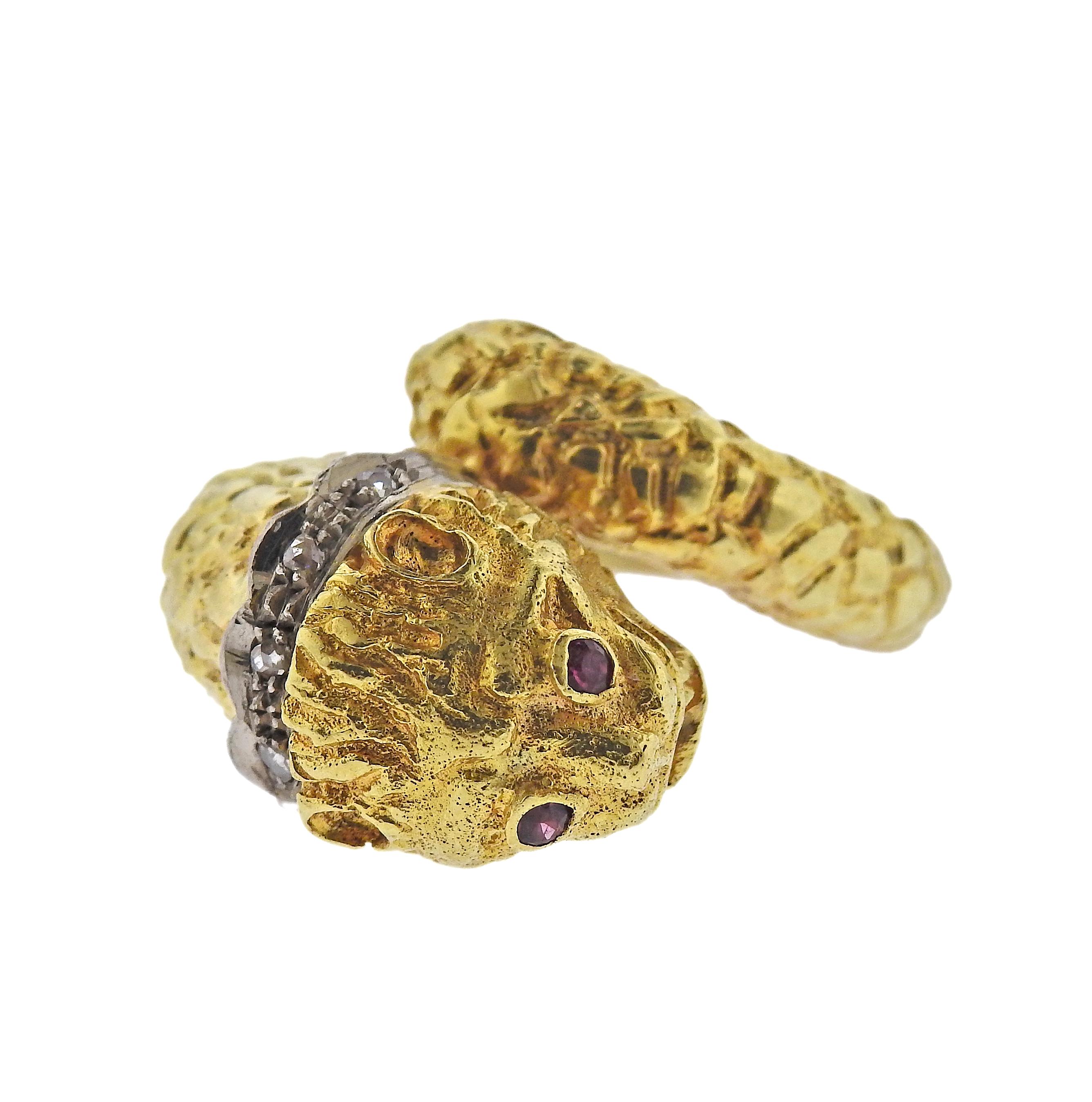 18k gold Chimera ring by Greek designer Ilias Lalaounis, adorned with ruby eyes and diamond collar. Ring size - 5, ring top is 18mm. Marked: 750, A21, Maker's mark. Weight - 11.6 grams.