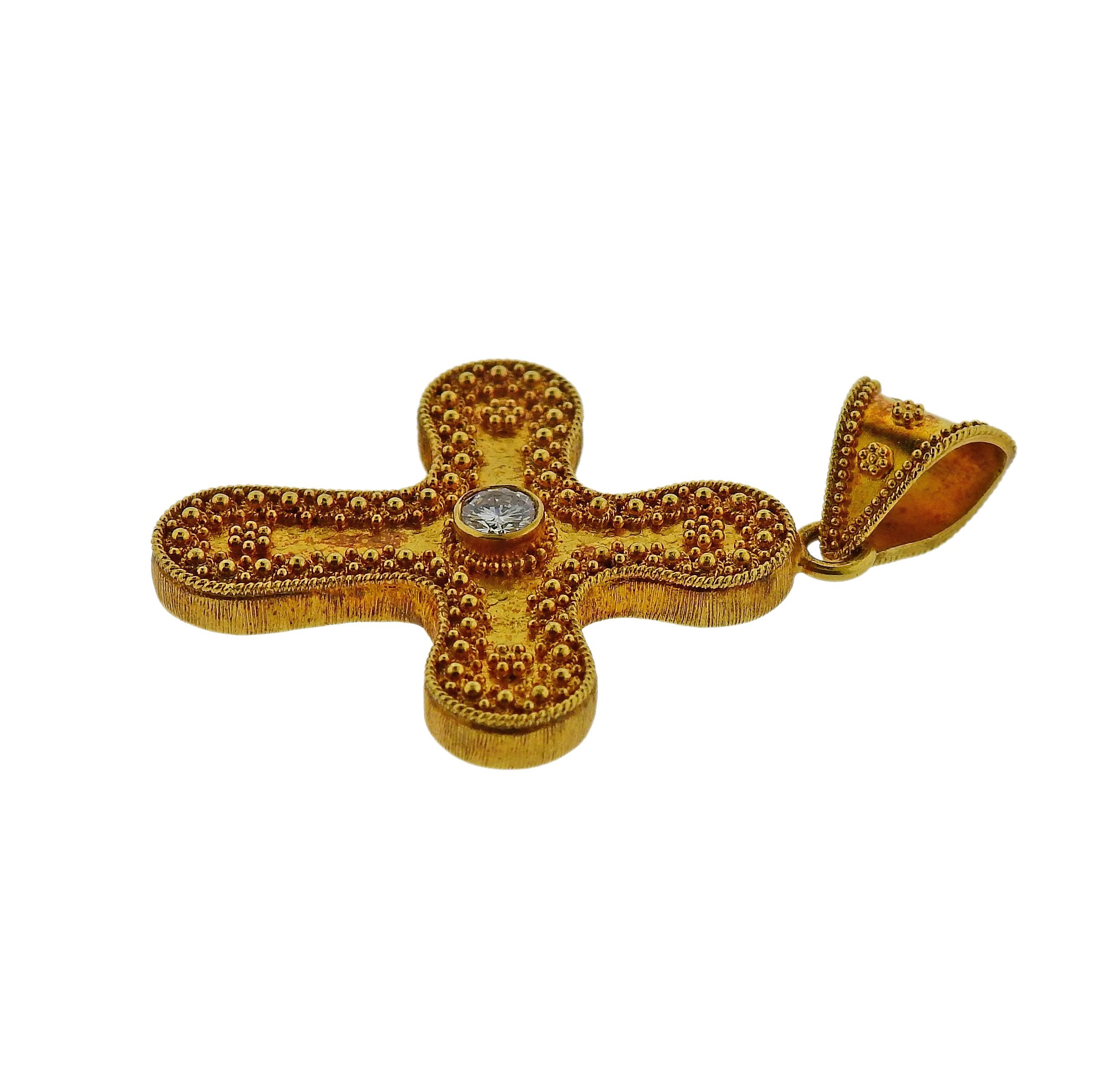 18k yellow gold cross pendant by Greek designer Lalaounis, set with an approx. 0.22ct H/VS diamond in the center. Pendant measures 45mm long with bale x 30mm. Weight is 10.7 grams. Marked 750, Greece, Maker's mark. 
