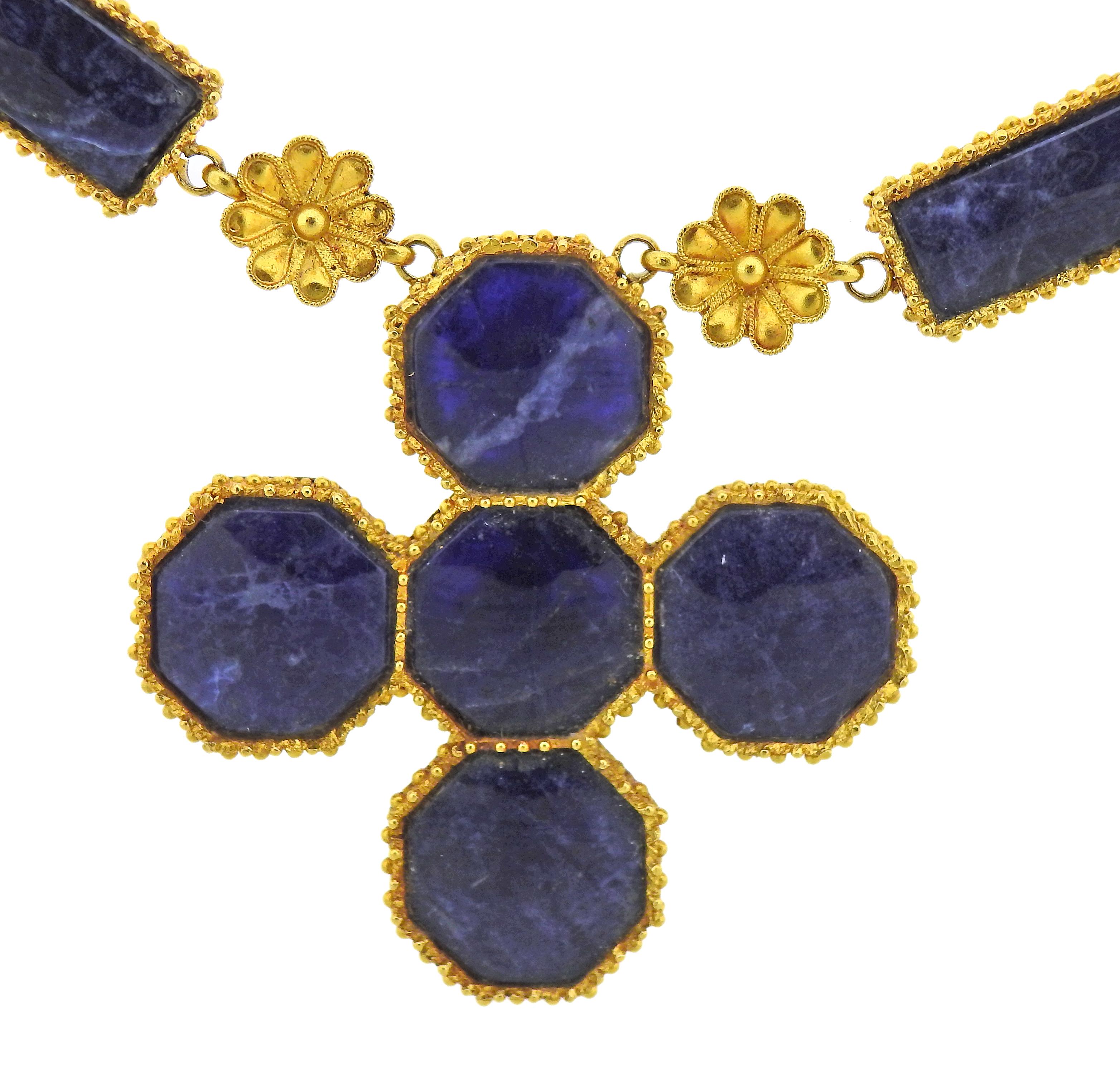 22k yellow gold necklace by Ilias Lalaounis, with cross pendant, set with sodalite stones. Necklace is 26
