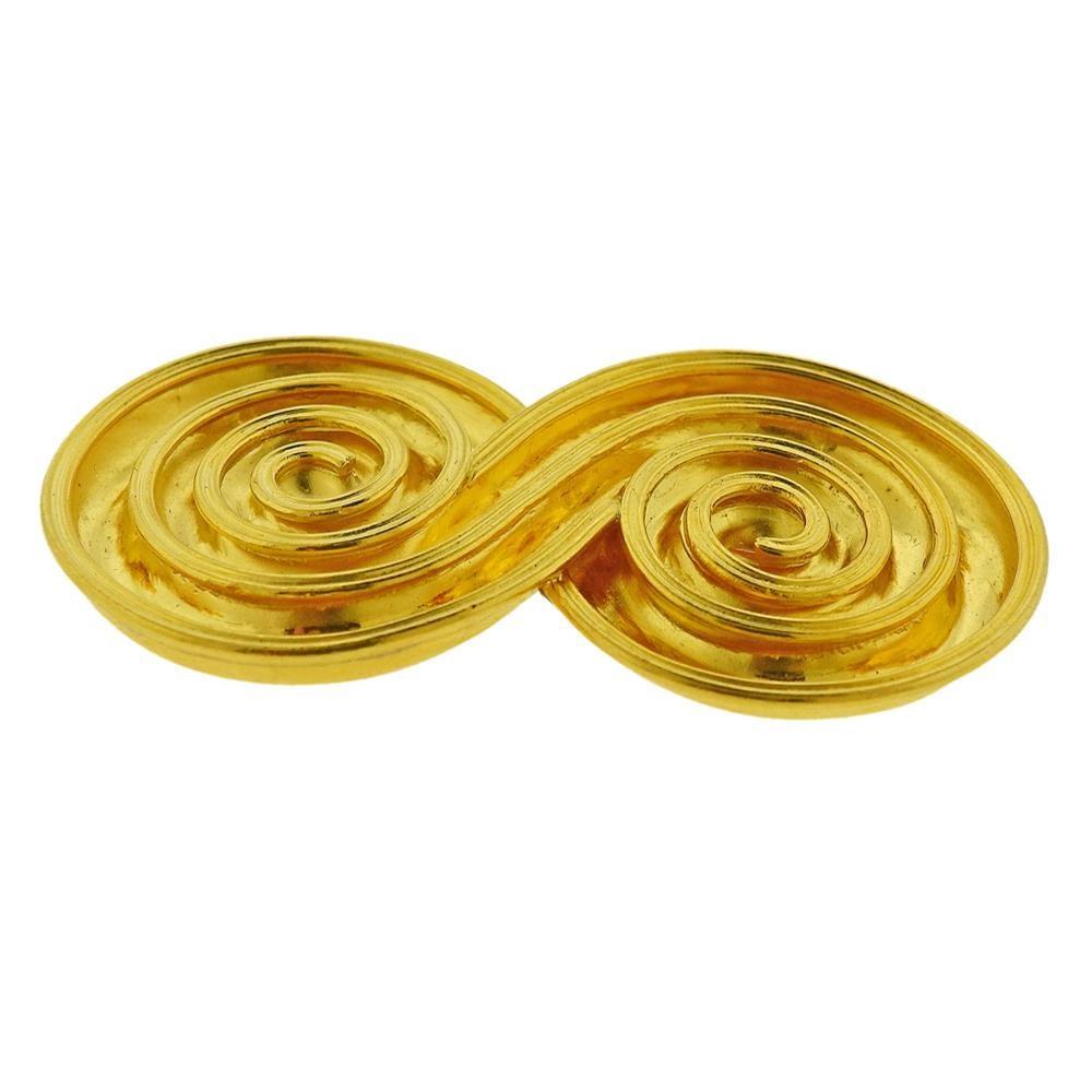 Greek 18k yellow gold double swirl brooch, crafted by Ilias Lalaounis. Marked: 750, Lalaounis mark, Greece. Weight - 24.2 grams. Dimensions: length 1.38 inch, width 2.5 inches, and depth 0.13 inch. 
