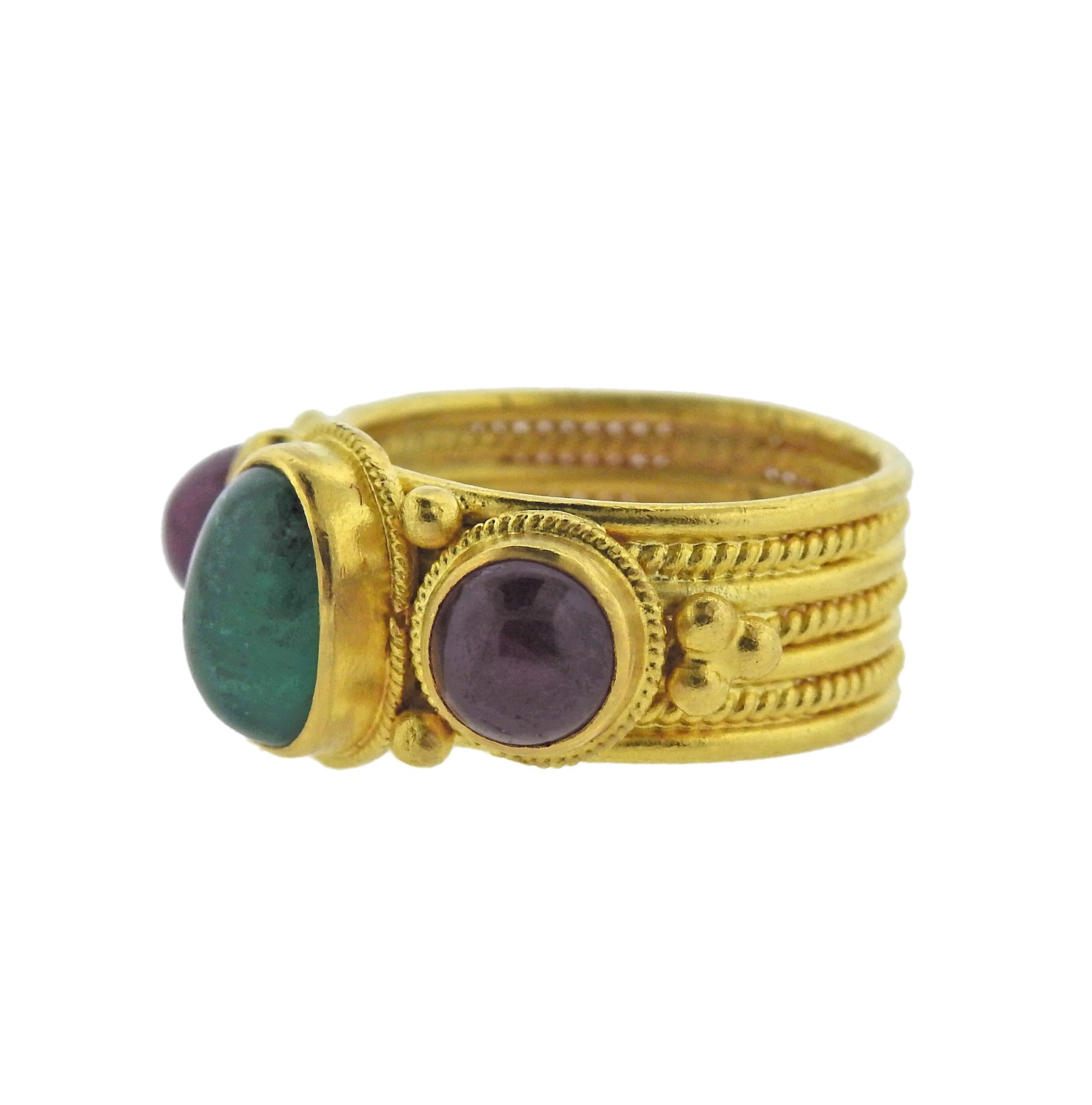 18k yellow gold cuff band ring, crafted by Greek designer Ilias Lalaounis, set with ruby and emerald cabochons. Ring size - 5.5, ring top is 11mm wide, weighs 10.7 grams. Marked: A.8, 750, Greece, Maker's hallmark.