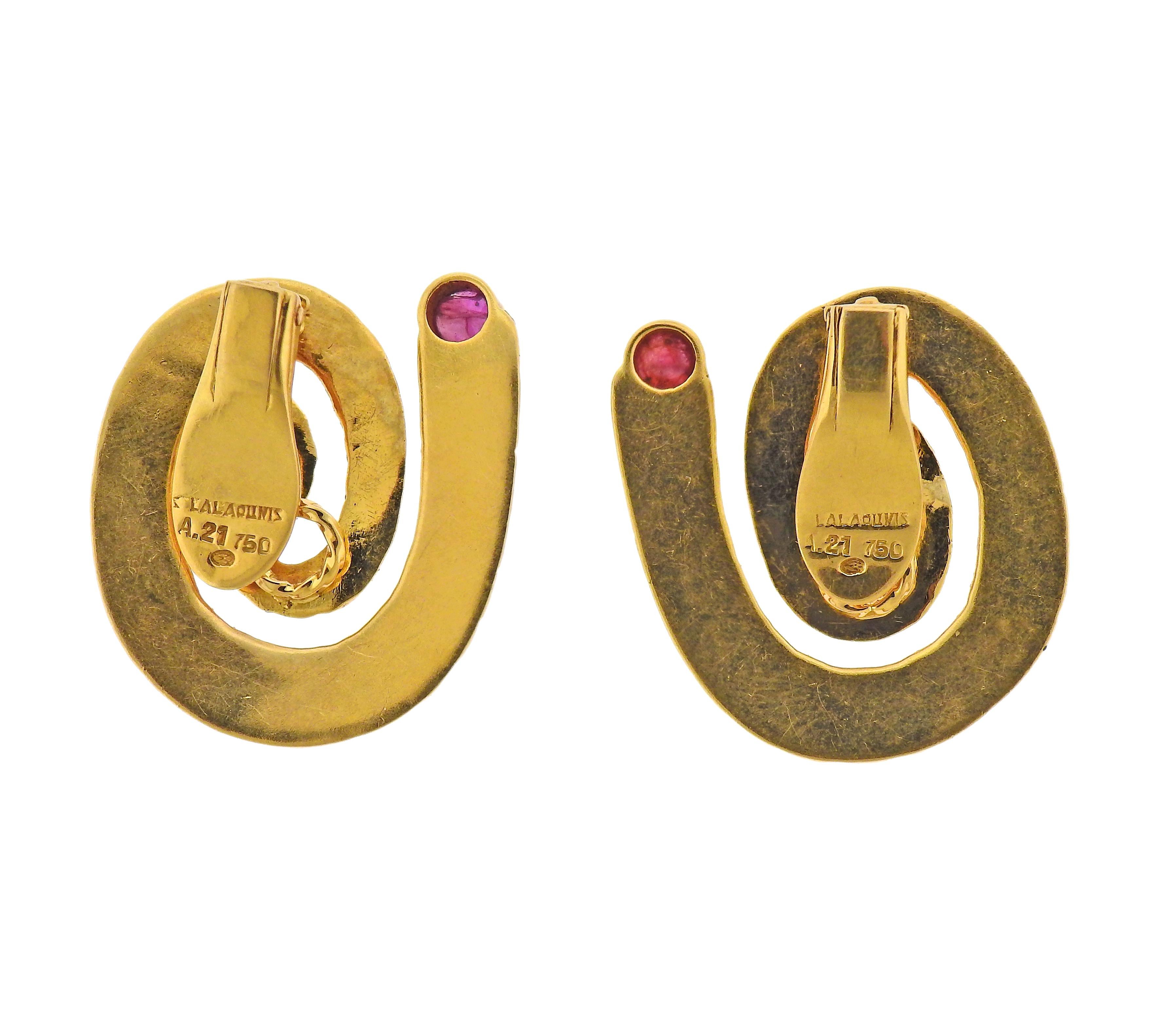 Pair of large 18k gold swirl earrings with rubies. Designed by Ilias Lalaunis, measuring 30mm x 25mm. Marked: A21, 750, I. Lalaounis. Weight - 16.4 grams. 