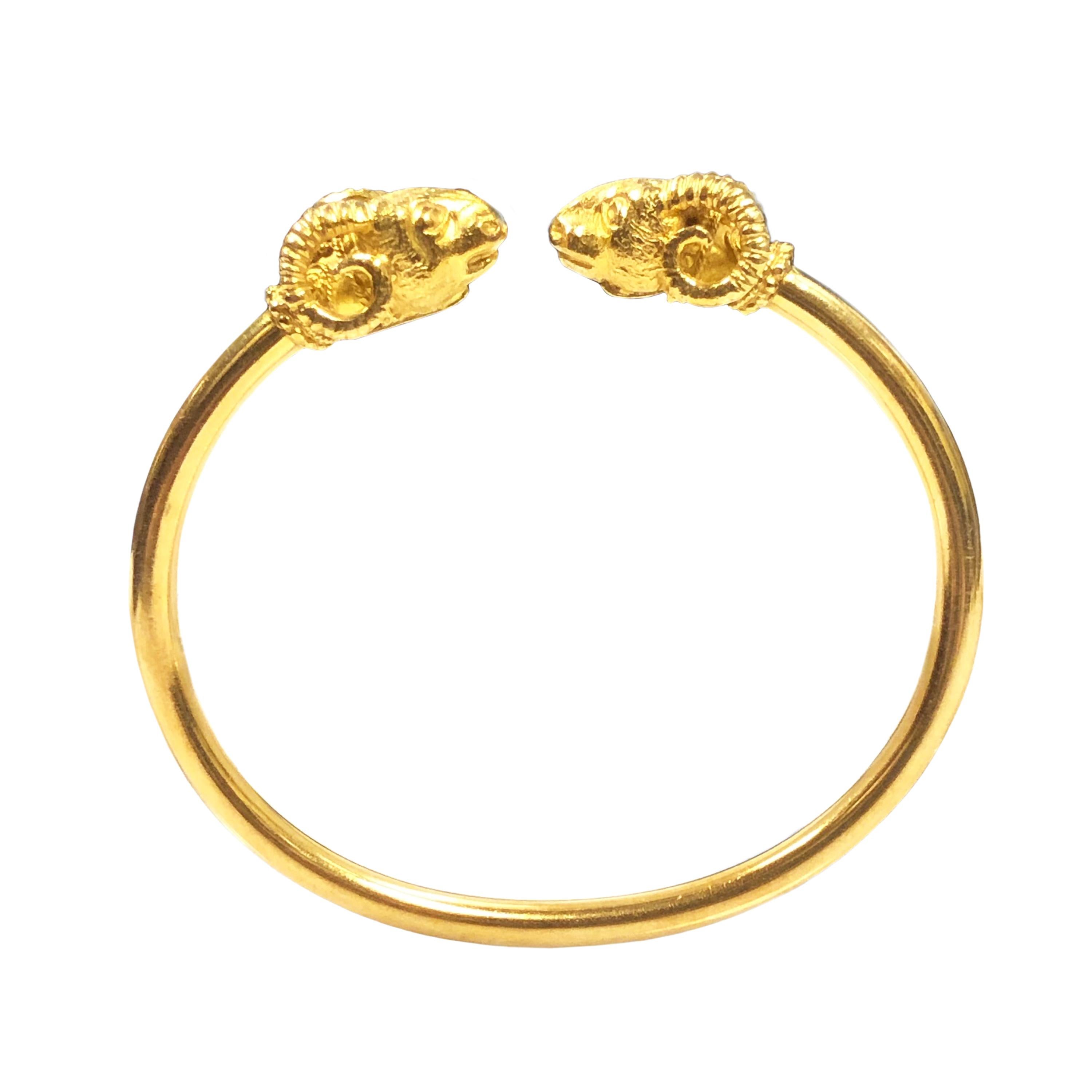 Circa 1990s Ilias LaLaounis Greece 18K yellow Gold Rams heads 3.5 MM thick cuff Bracelet.  The Detailed Rams Heads measure 3/4 X 1/2 inch, the inside measurement of the Bracelet is approximately 6 3/4 inches. 