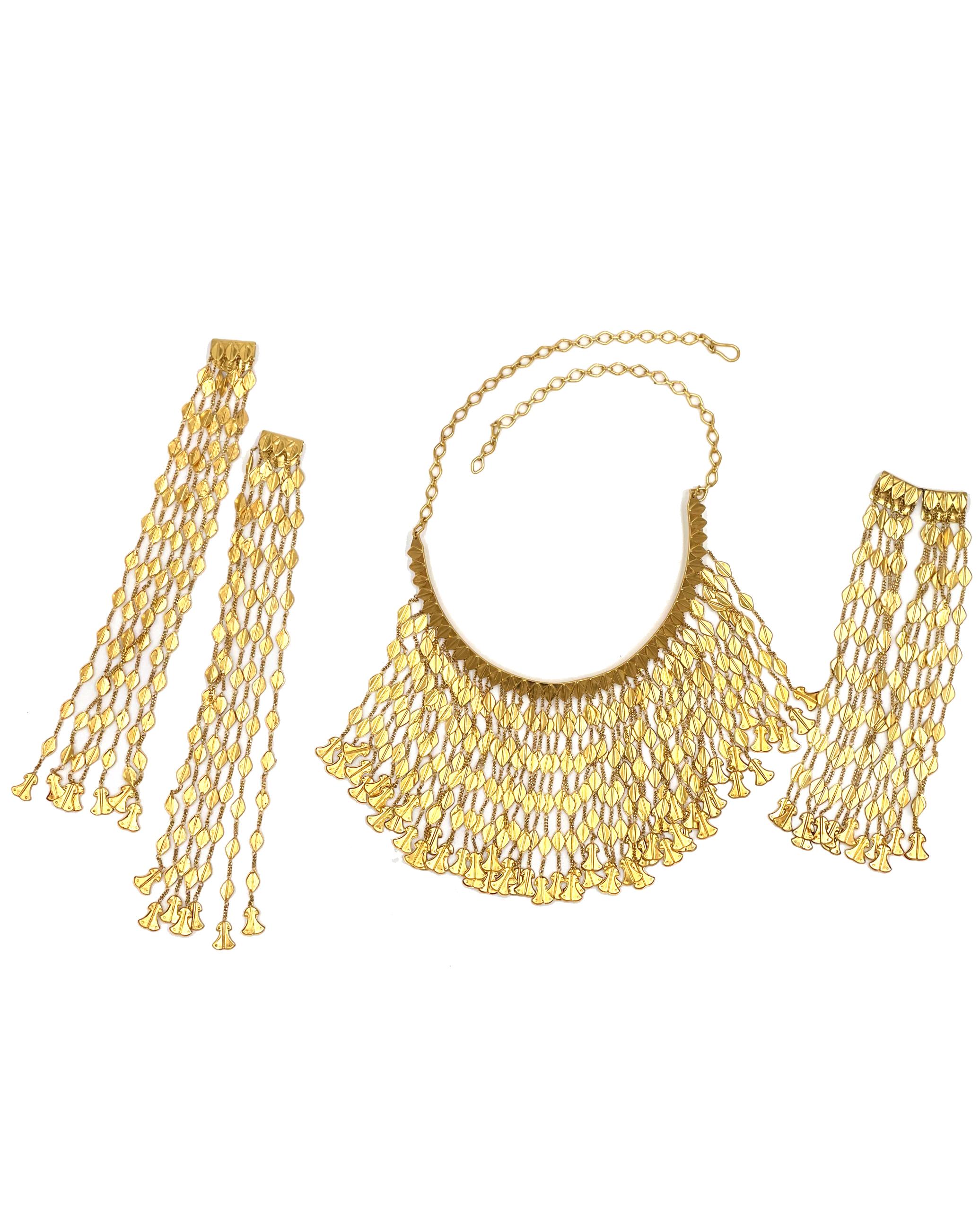 Pre owned vintage 18K yellow gold necklace by Ilias Lalaounis, Helen of Troy Collection. The necklace has a curved center bar that has a fringe of chain pieces.  The fringe is 56 strands, each one 6 inches long.  The necklace weighs 107.3