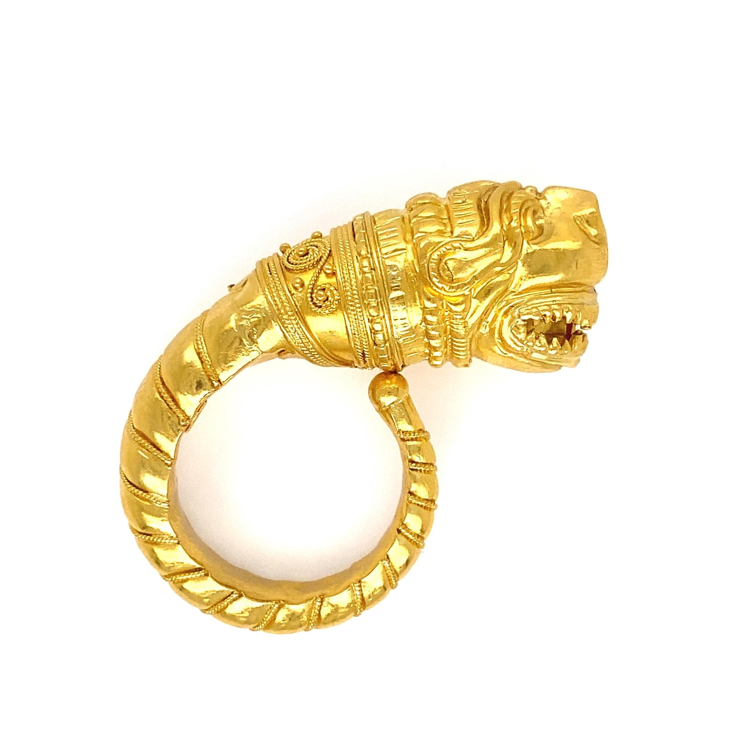 Simply Beautiful Lalaounis Iconic Ornate Dragon Gold Ring by Ilias Lalaounis. Hand crafted in 18K and 22K yellow Gold. Dimensions: 1.47”w x 0.45”h x 1.07”d. Ring size 5.5. Marked. Approx. weight 9.10 grams. Classic and Chic…The perfect accessory for