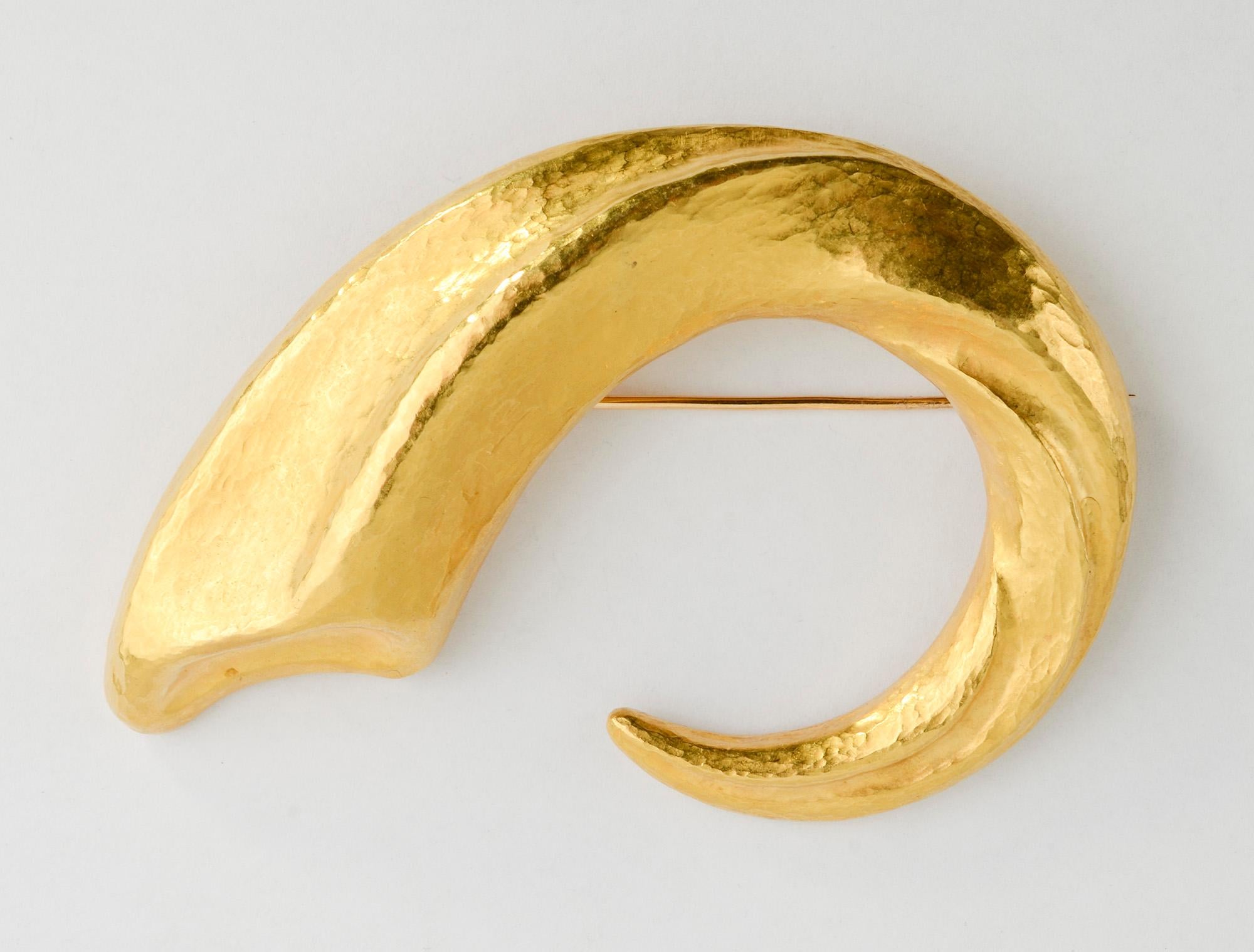 This bold and sculptural brooch by laLaounis is wonderfully versatile. It looks terrific whether worn vertically; horizontally or at an angle. It has a hammered, matte finish often seen in the work of laLaounis.  The gold is brilliantly sculpted to