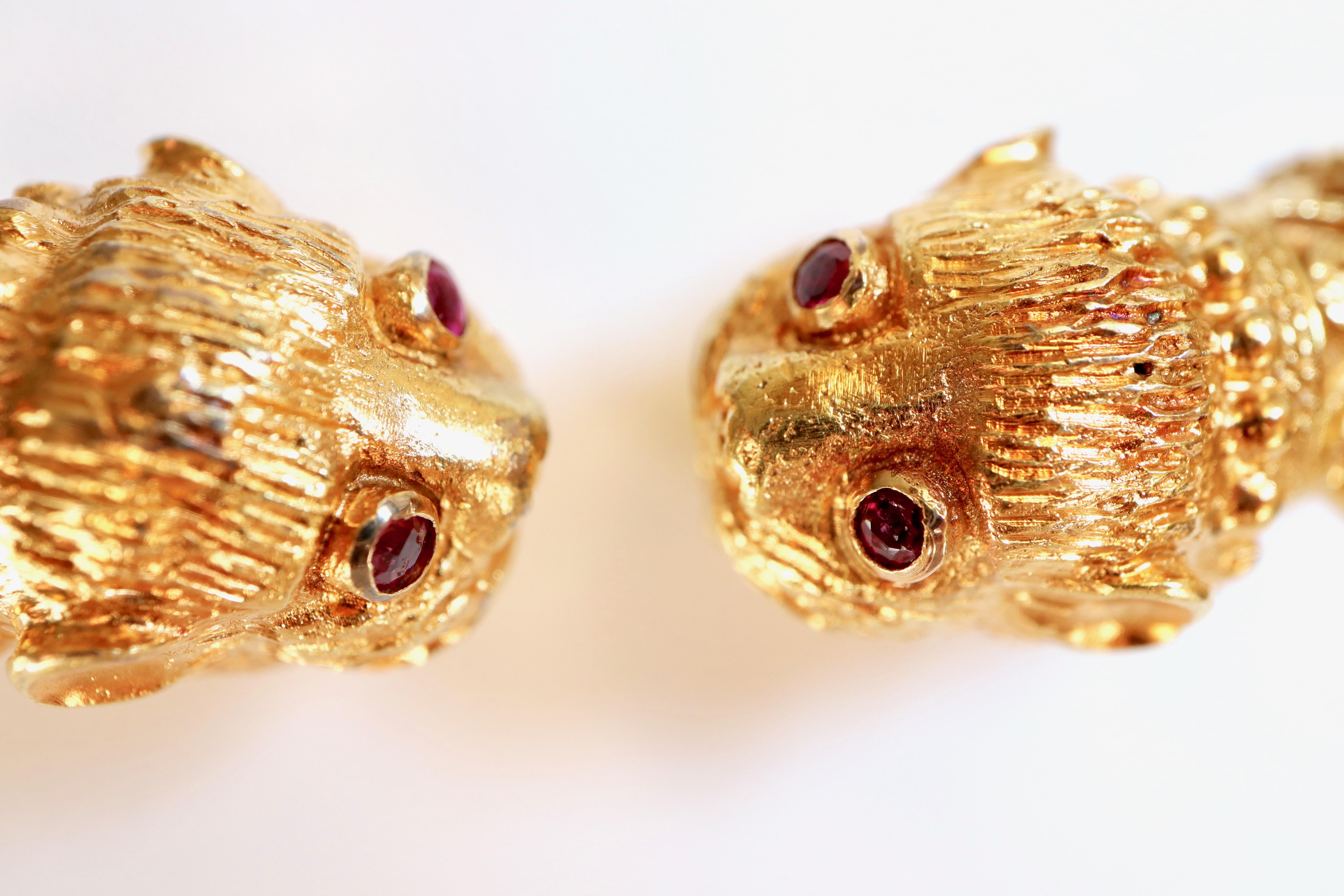 Collana rigida Lalaounis in oro giallo 18 carati Zaffiri e rubini Teste di leone
Collana tubolare semirigida con una testa di leone cesellata alle estremità con occhi di rubino, la parte anteriore della collana con un rubino cabochon e 4 zaffiri in