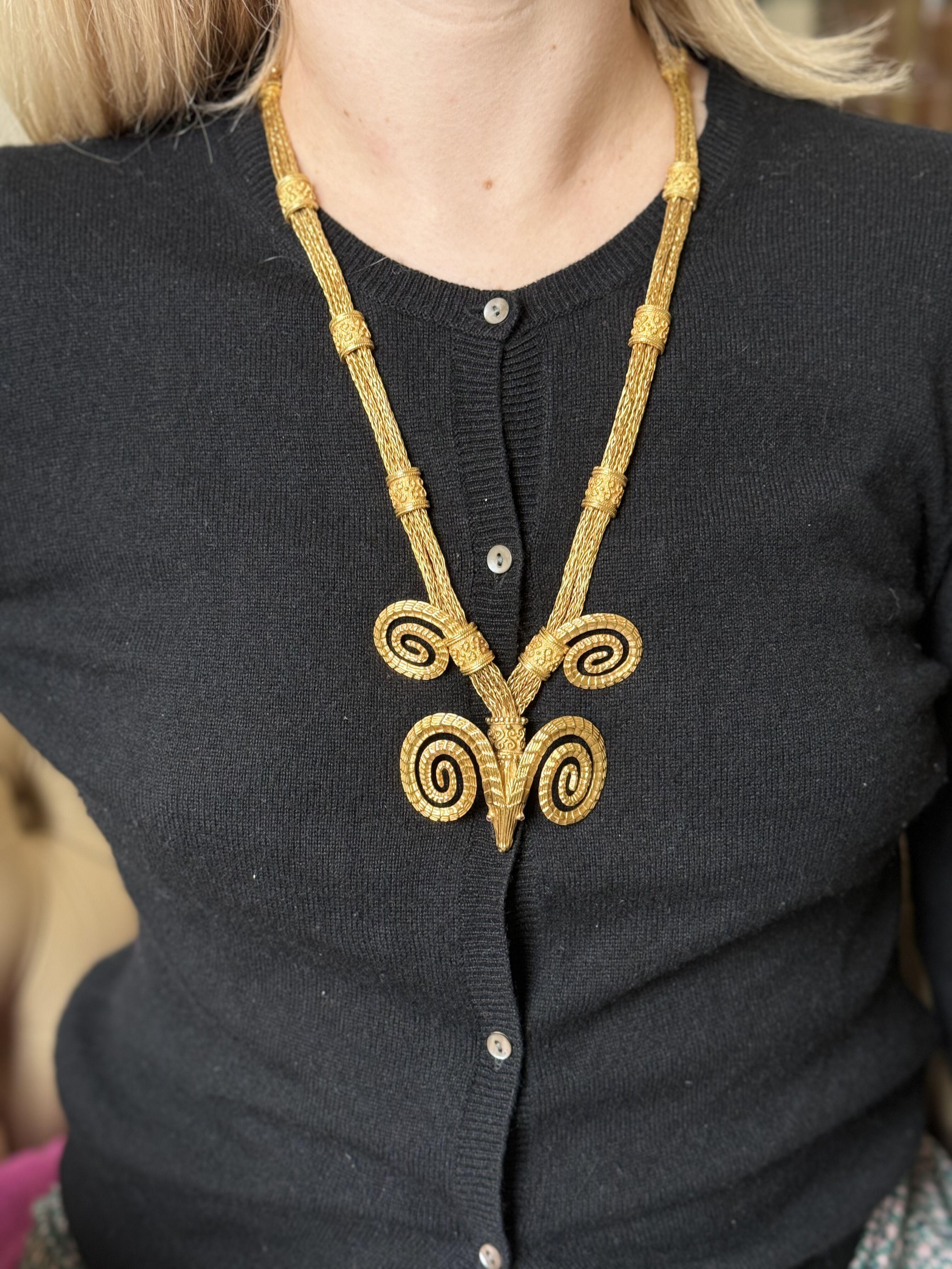 Iconic ram's head necklace by Ilias Lalaunis of Greece, with ruby eyes. The necklace is 18k yellow gold, measuring 27
