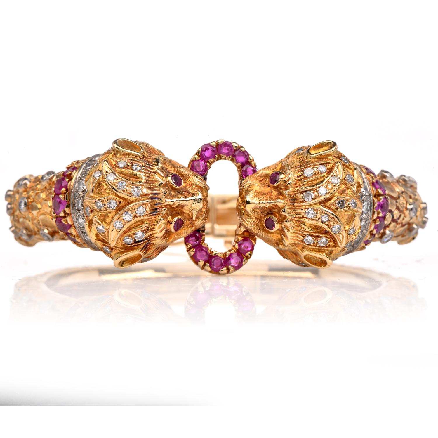 This Vintage Iconic Greek Bangle bracelet by famous Greek designer Lalaounis is created in 18k yellow gold. This highly collectible Lalaounis cuff bangle bracelet is centered with 2 impressive lion heads with genuine ruby eyes and diamonds on the