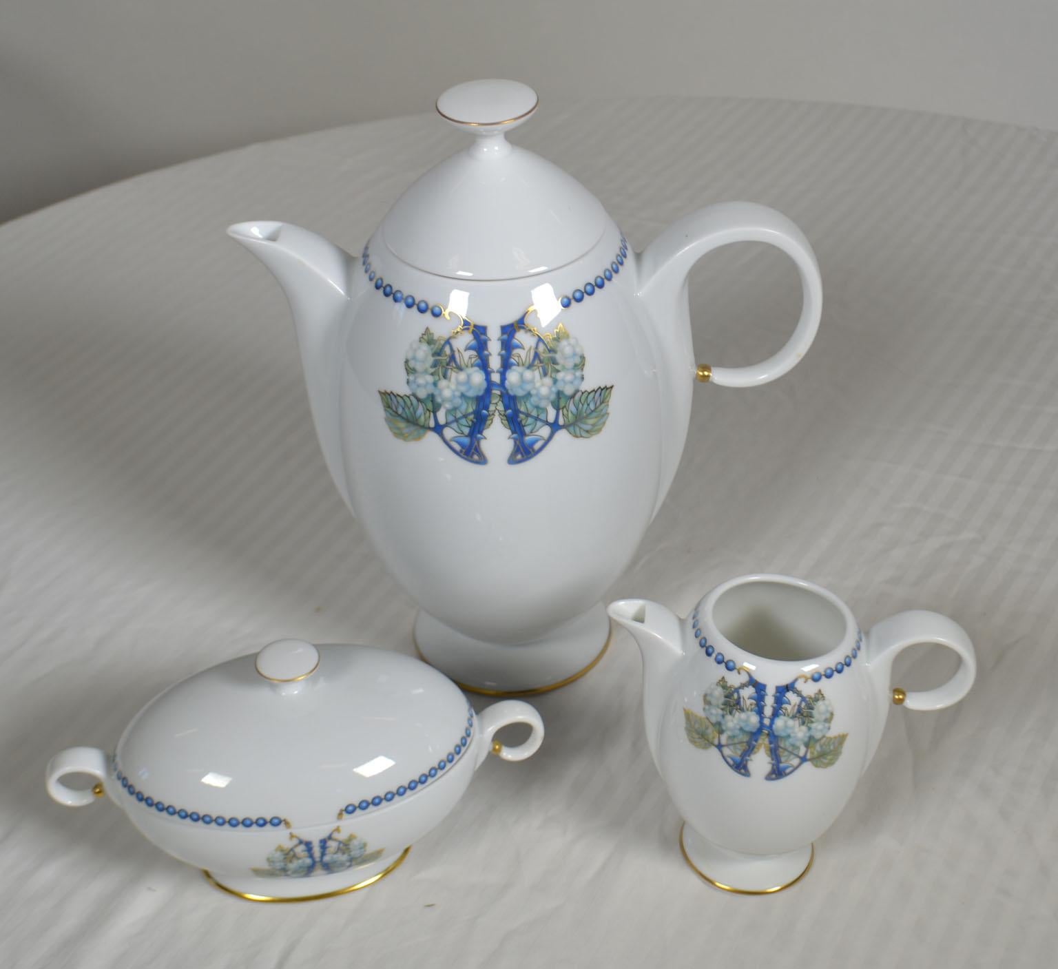 3-piece white, blue and multicolored Limoges porcelain Lalique Mûres Blackberry coffee set with beaded motif at rims, gilt accents throughout and brand stamp at undersides. Includes 1 coffee pot, 1 creamer and 1 sugar bowl. Made in France.