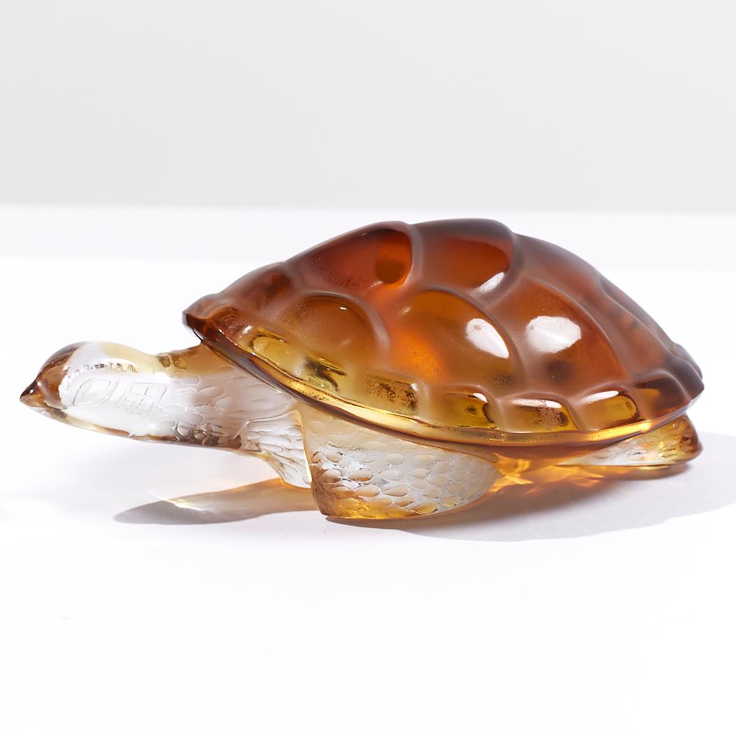 Lalique Amber-Colored Glass Turtle

This sculpture measures: 3.5 wide x 5.75 deep x 2.5 high

We take our photos in a controlled lighting studio to show as much detail as possible. We do not photoshop out blemishes. 

We keep you fully informed