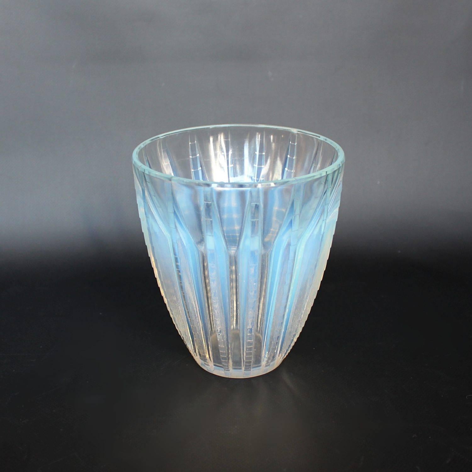 Chamonix, an Art Deco vase. A frosted and opalescent glass vase, relief decorated with stylised pattern.

Stencil etched R Lalique France to underside.

Marcilhac, R Lalique Catalogue Raisonné de L’Œuvre de Verre p.458, Model number