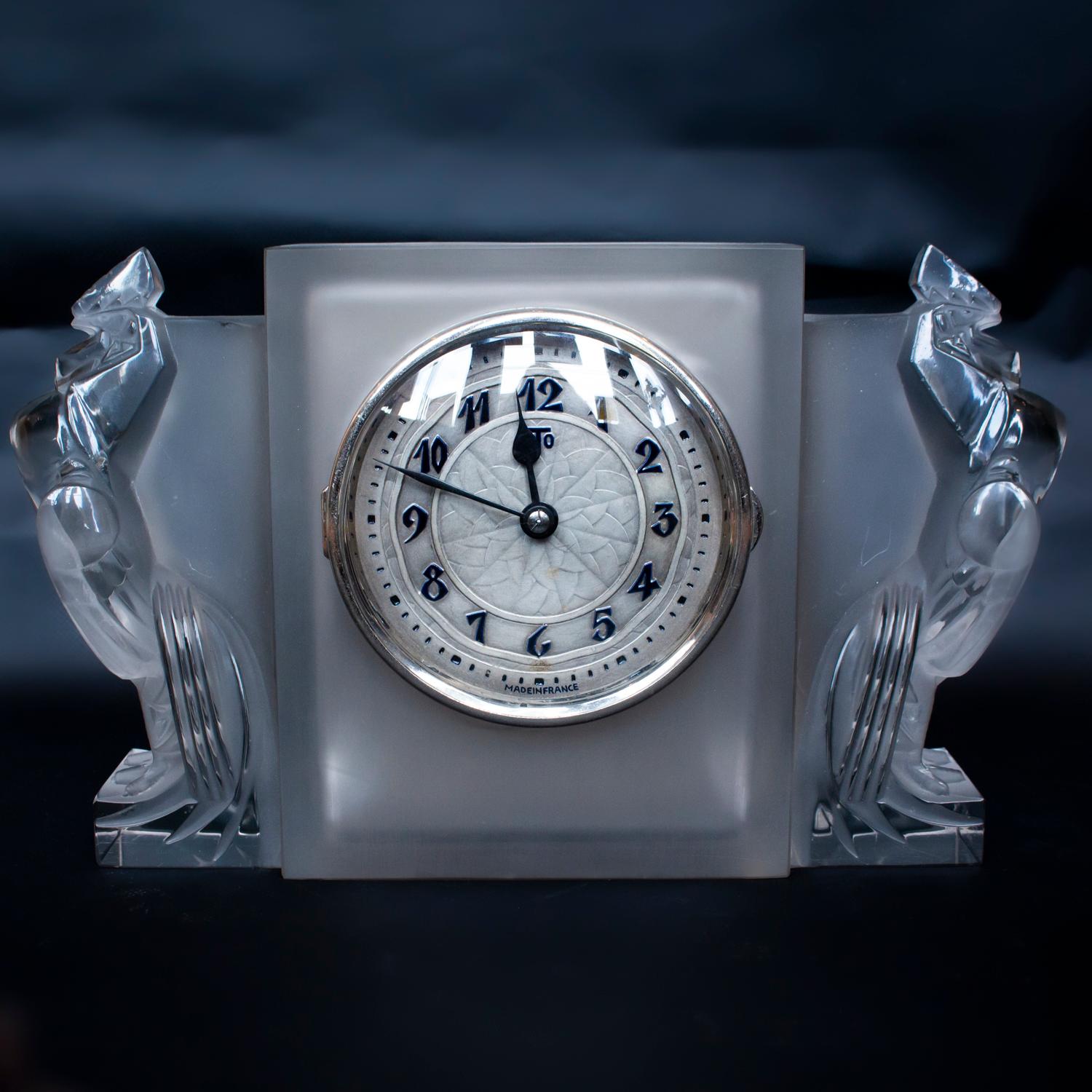 'Deux Coqs', an Art Deco glass mantel clock by René Lalique, (1860-1945). A frosted glass case flanked by a pair of clear glass Coq Houdan mascots. With original ATO clock fitting and battery (battery will need replacing). Model number 730. First