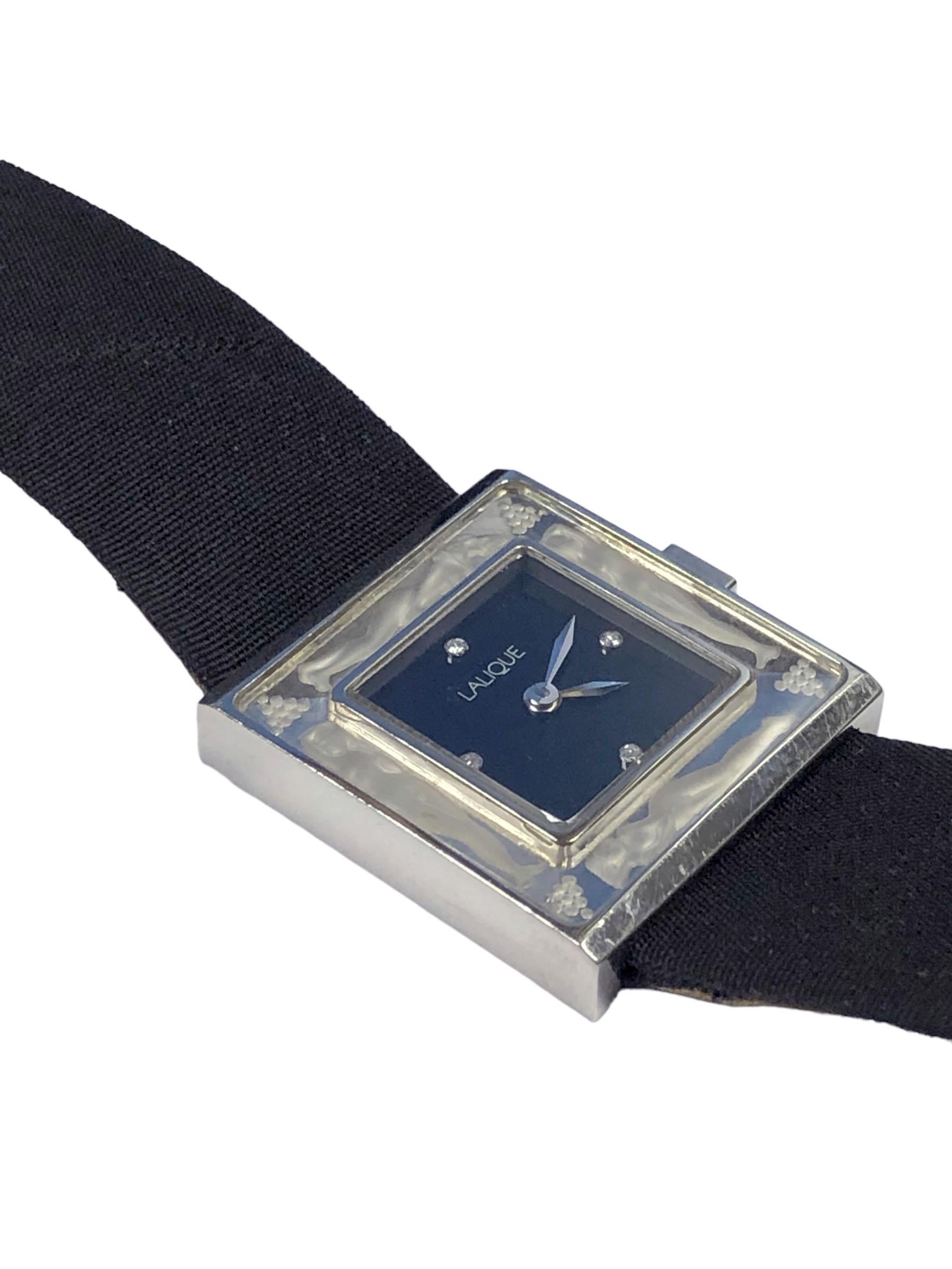 Circa 1990s Lalique Bacchantes Wrist Watch, 23 X 24 M.M. 2 Piece Stainless Steel case with inset Crystal, quartz movement, Black dial with 4 Diamonds. Original Black Satin Strap with original Steel buckle. Watch length 8 inches. 