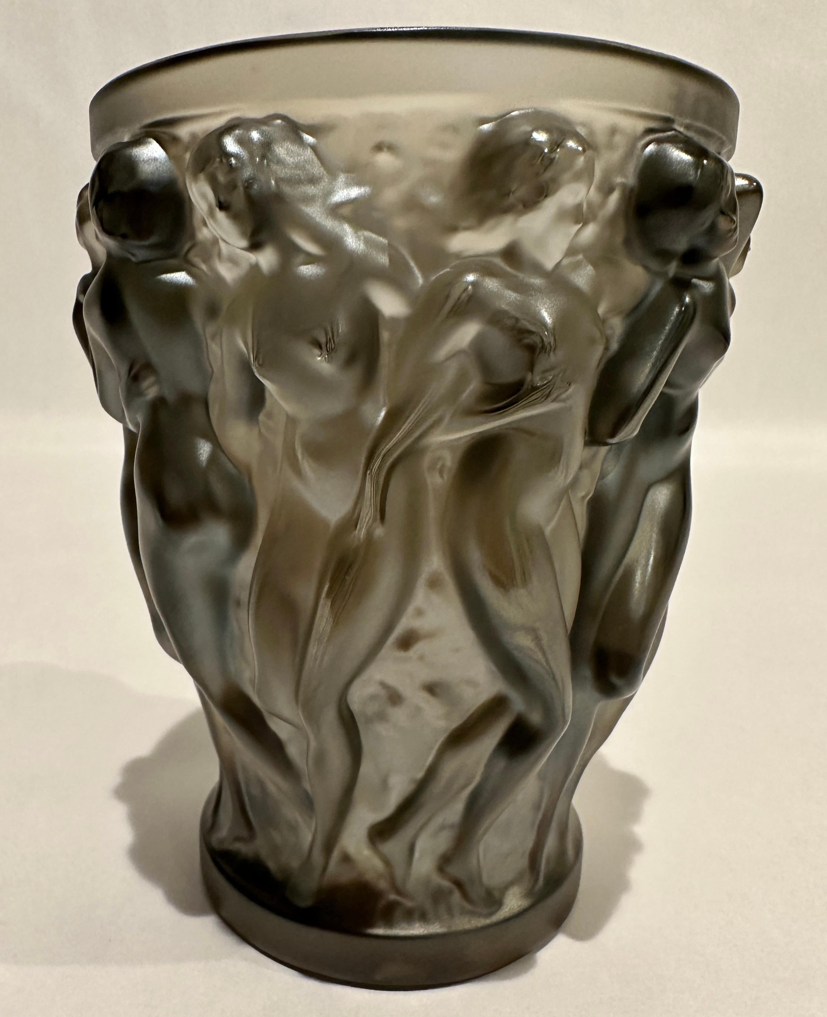 Lalique Bacchantes crystal vase in bronze-tone satin, signed at bottom. Original clear Lalique label.

In 1927, Rene Lalique's boundless imagination and creative genius lead to the creation of the Bacchantes Vase. As a splendid insolent and a