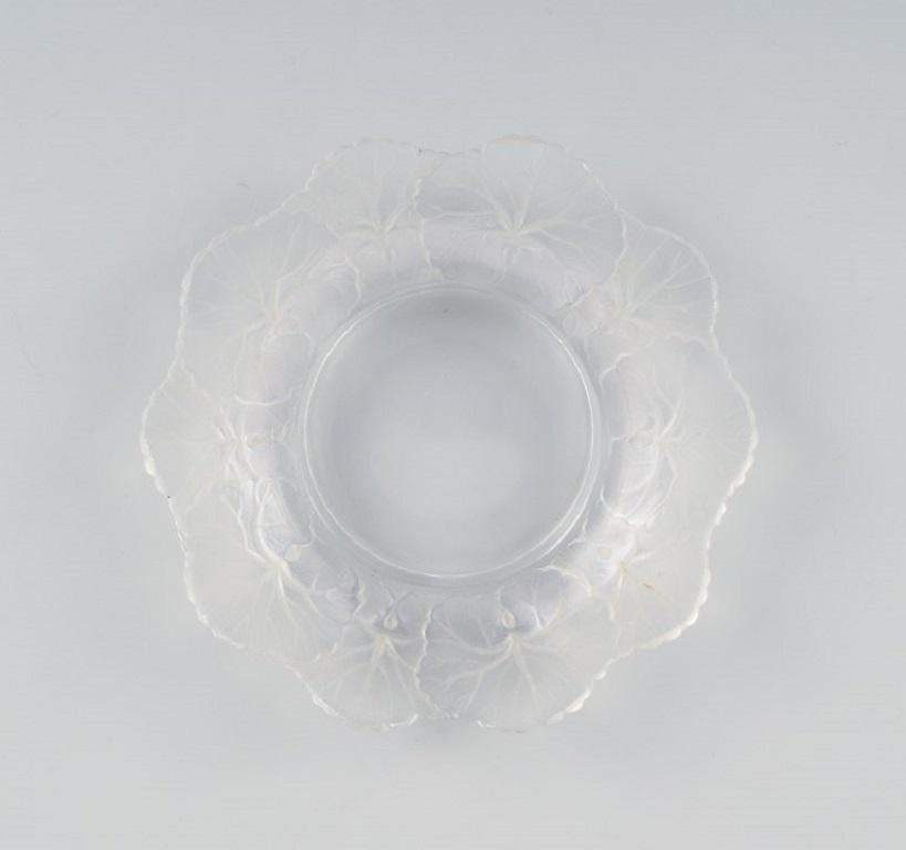 Lalique bottle tray in clear art glass with flower decoration.
Approx. 1980.
D 14.5 cm. x H 2.5 cm.
Fits bottle base of 7.0 cm
In perfect condition.
Engraved signature 