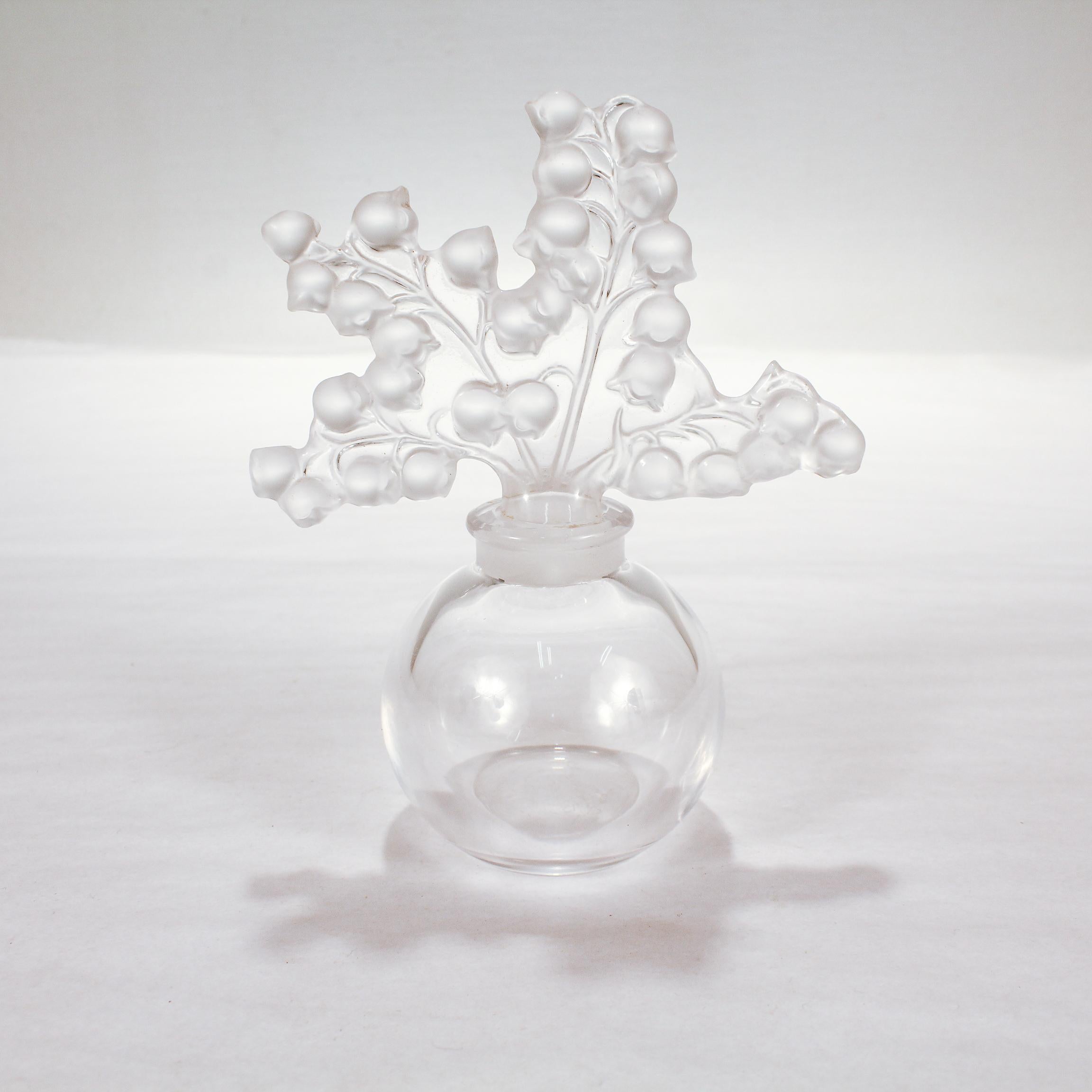 A fine art glass perfume bottle.

By Lalique.

Entitled 'Clairefontaine' - a reference to the Clairefontaine garden – located in the South West of Paris (France) – which was one of René Lalique's major source of inspiration. The perfume bottle