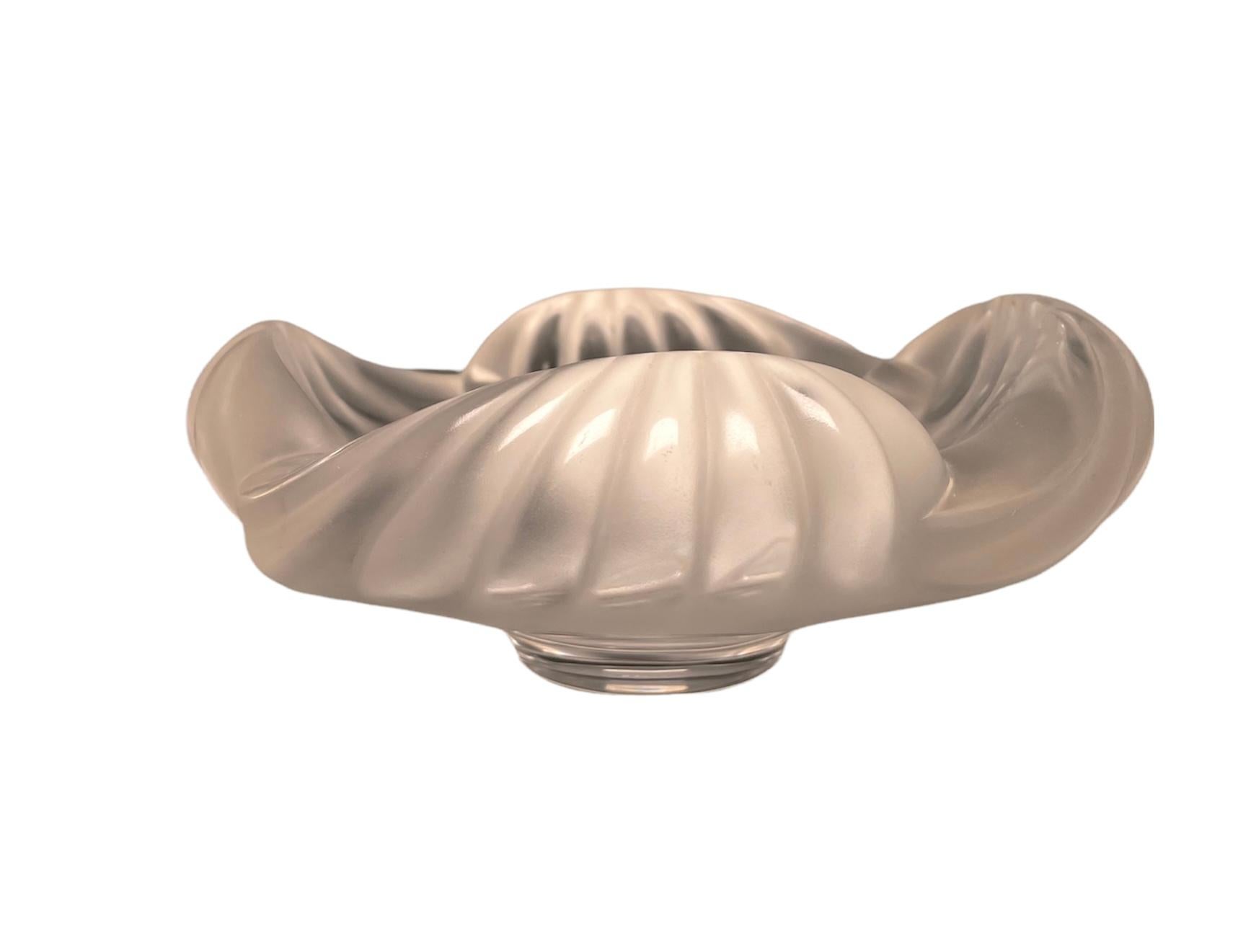 This is a Lalique Crystal “Aruba” cigar ashtray. It depicts a clear and frosted crystal heavy round bowl with furrowed waves rim. It is hallmarked Lalique encircled R, France.