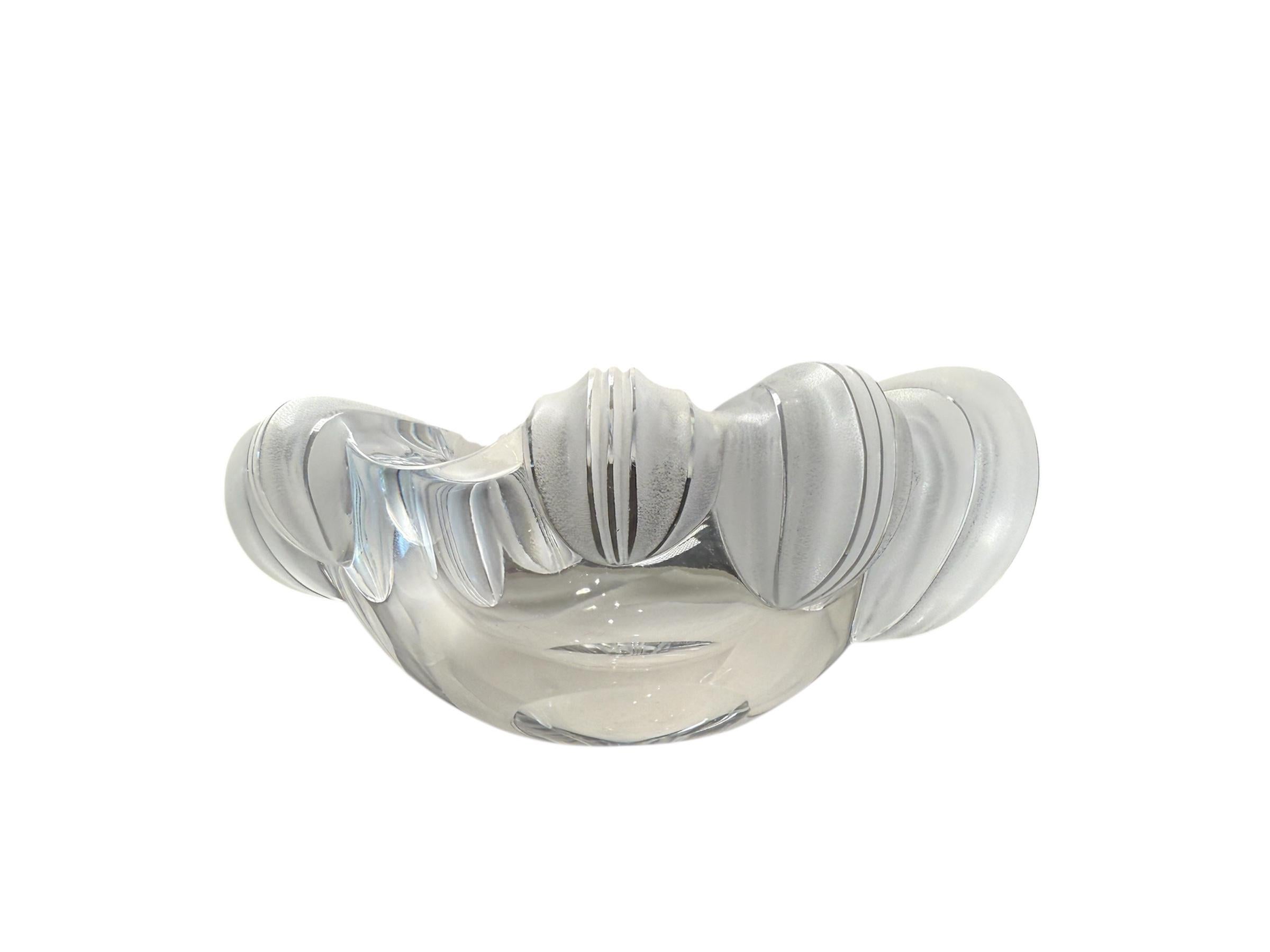 This is a Lalique Crystal “Athena” cigar ashtray. It depicts a clear and frosted crystal heavy round bowl adorned by large shells in its border. It is hallmarked Lalique encircled R, France.
