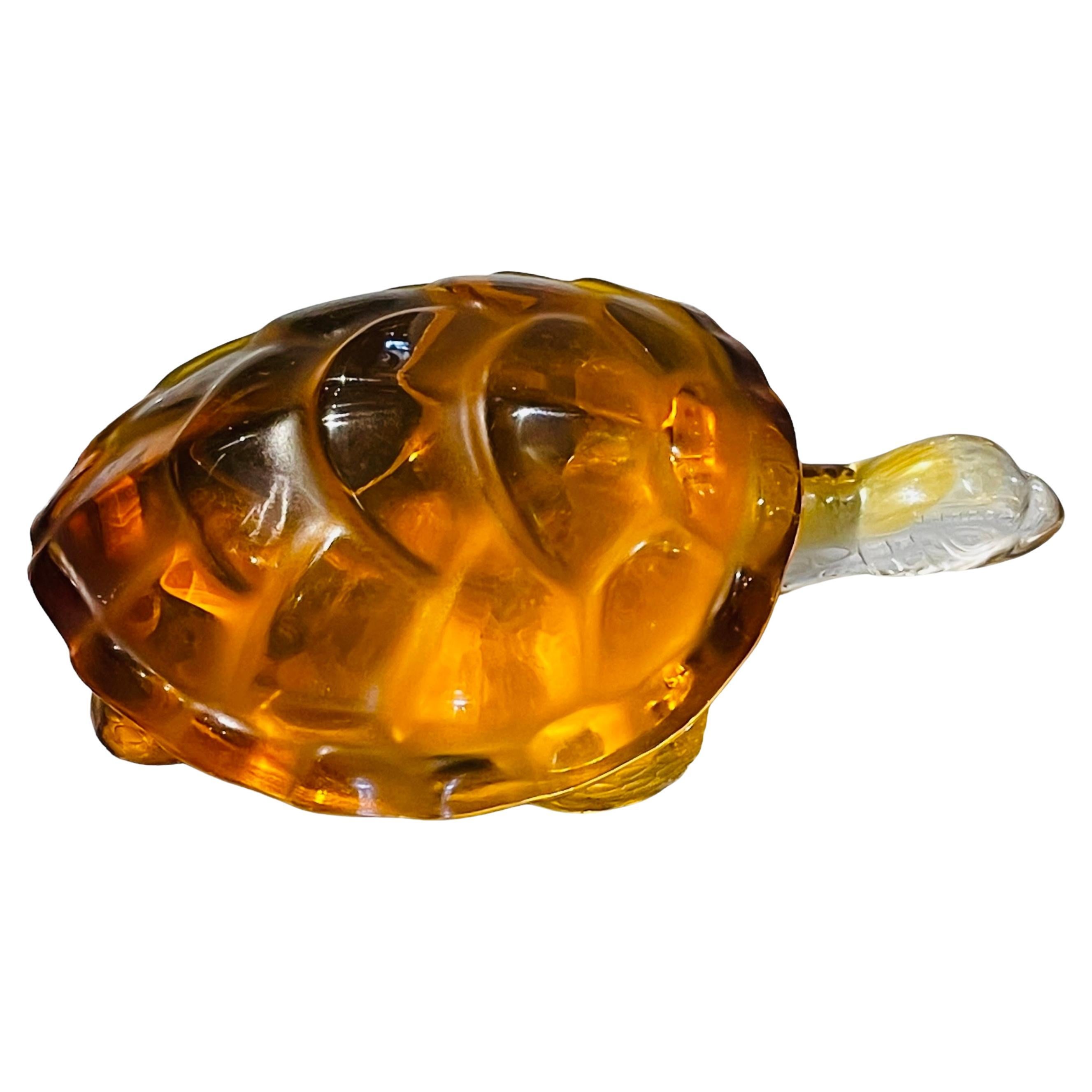 This is a Lalique Amber Crystal “Caroline”Turtle sculpture/paperweight. It depicts a turtle with an amber color crystal heart shaped carapace and clear crystal head, legs and neck. It is hallmarked Lalique encircled R, France.