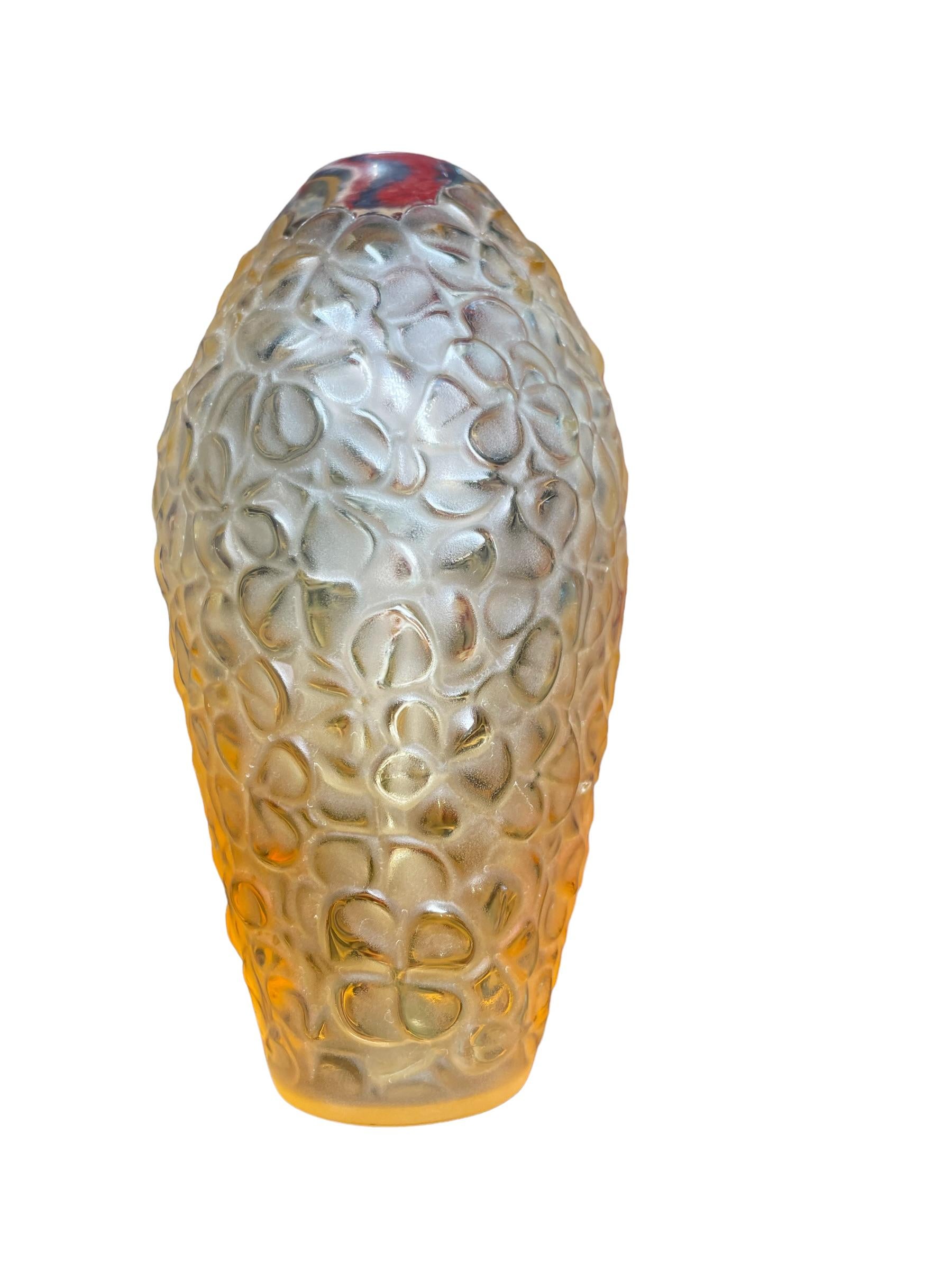 This is a Lalique Crystal “Violeta” clear to amberina color glass small flower vase. It depicts an elongated bulbous vase with multiple carved flowers. Below the base is the acid etched hallmark of Lalique, France.