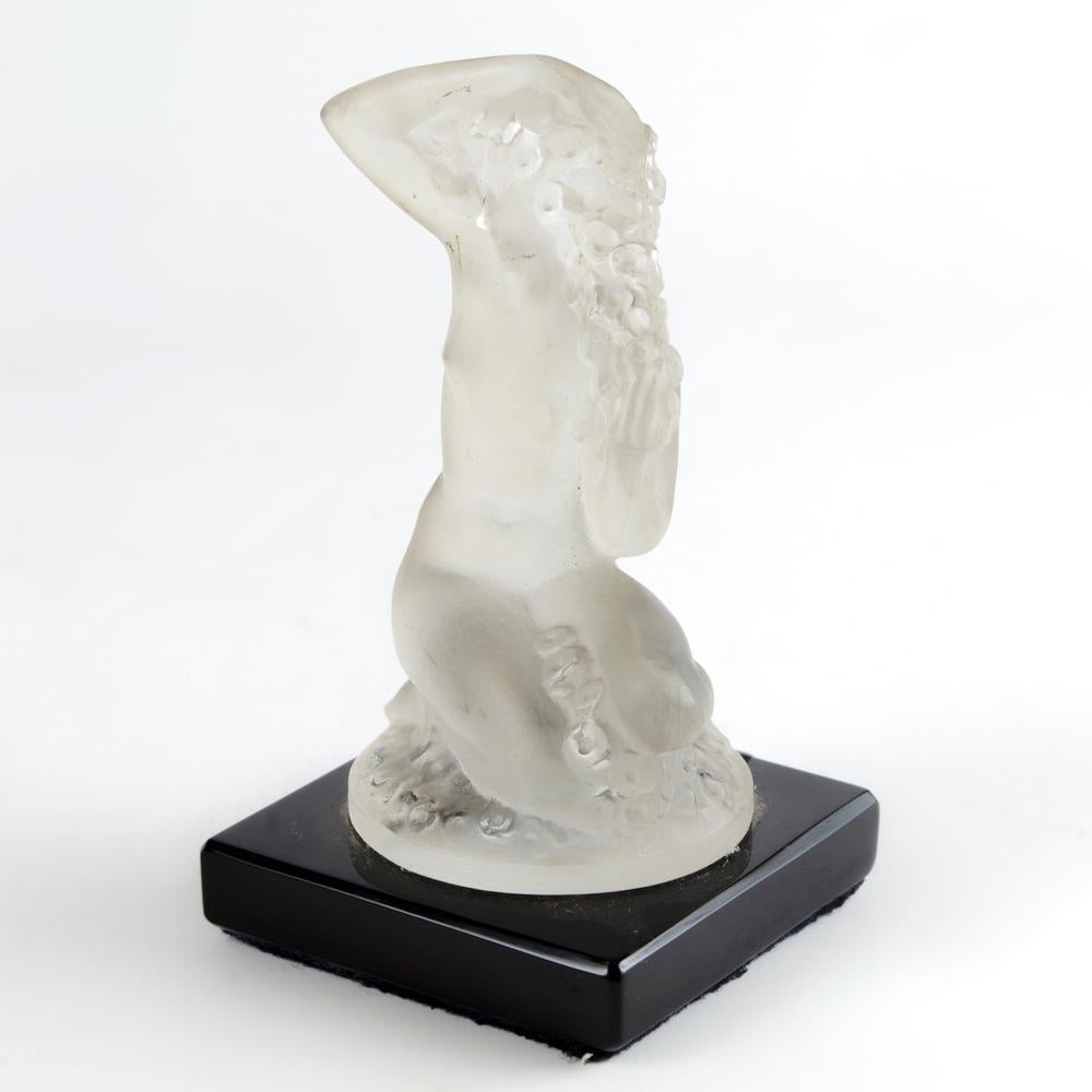 Beautifull Lalique Crystal Female Figurative Sculpture

A French Lalique crystal female figurative sculpture piece, circa 1970's, France. A nude crystal female figure sculpture on black glass base by luxury crystal maker Lalique. Piece is marked on