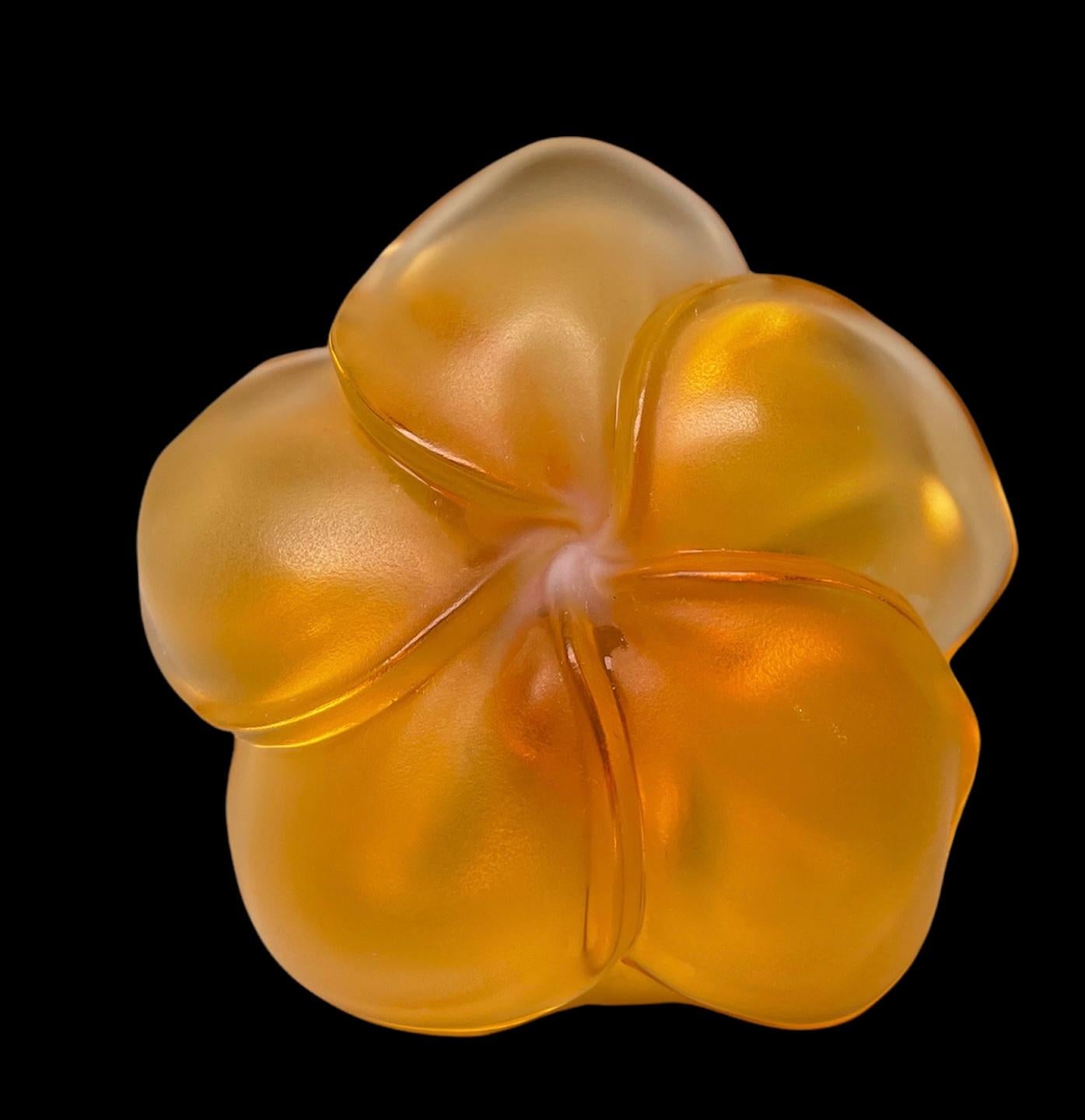 This is a Lalique amber crystal “Frangipani” ring holder/ pin dish shaped as a five petals Plumeria flower. It is signed Lalique, encircled R and France.