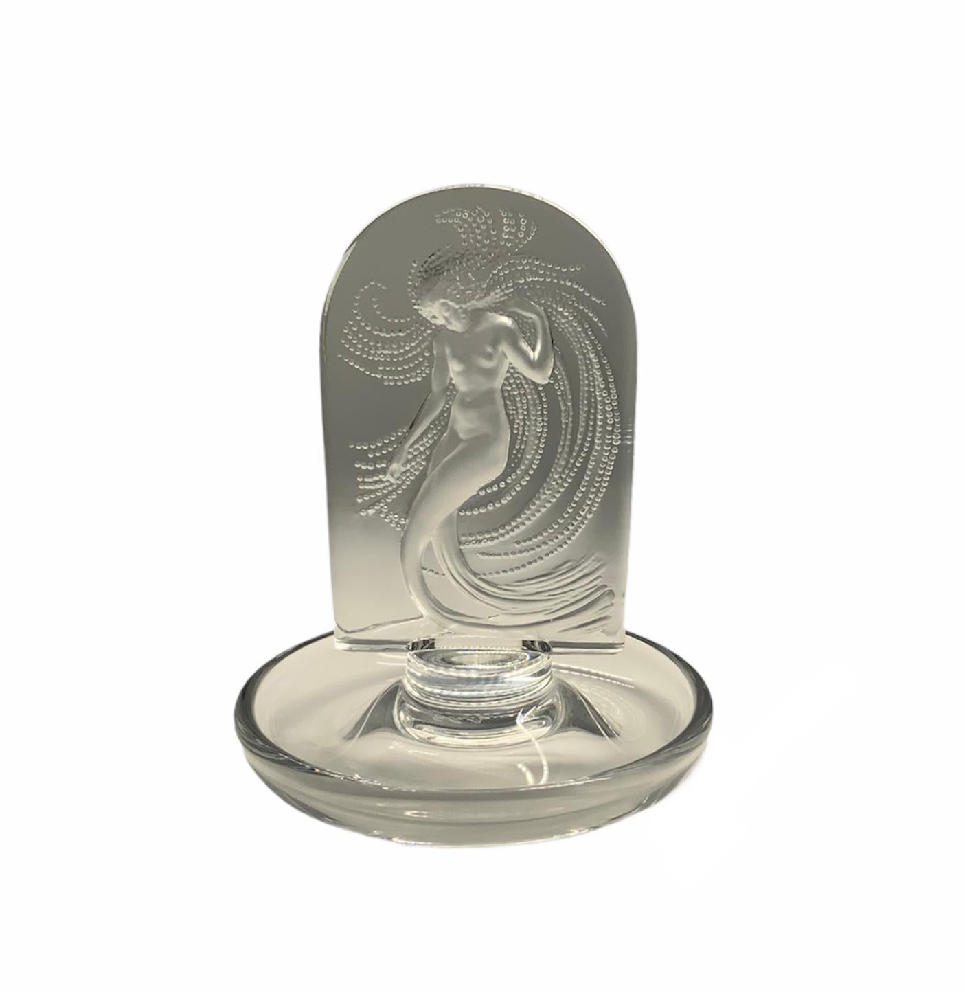 This is a Lalique crystal ring dish that depicts a clear plaque of a frosted nude nymph dancing while the water is splashing.