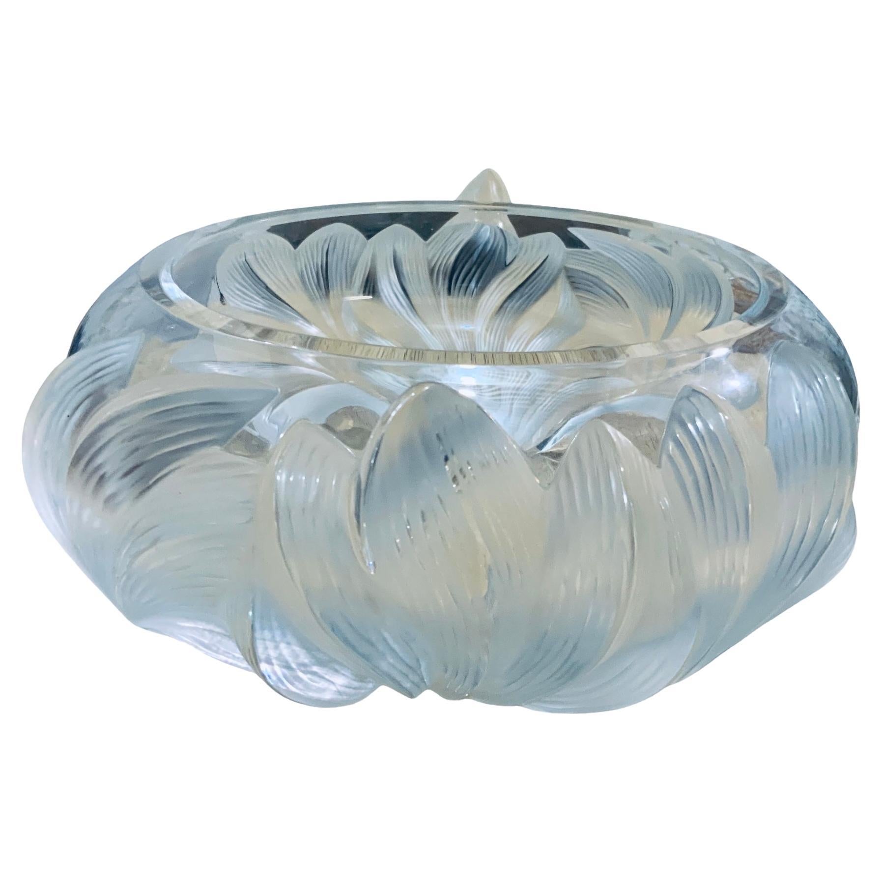 This is a Lalique frosted crystal “ Pivoine Peonies “ large round bowl centerpiece. It depicts a relief of frosted wide and long peonies flowers in two sides of the round bowl. Below the base, It is acid etched Lalique encircled R, France. Peonies