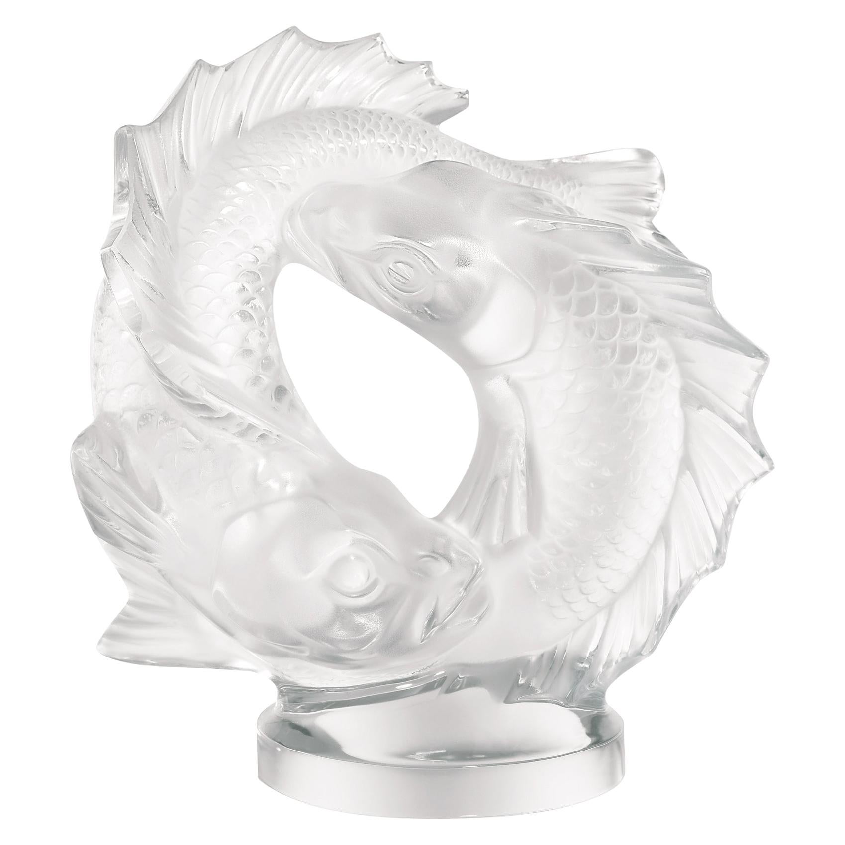 From the fish figurine created by René Lalique in 1913, to the car mascot ornament Perche, or the Roscoff bowl, the fish has often inspired Lalique creations. On this large satin crystal figure, designed in 1953 by Marc Lalique, two fish appear to