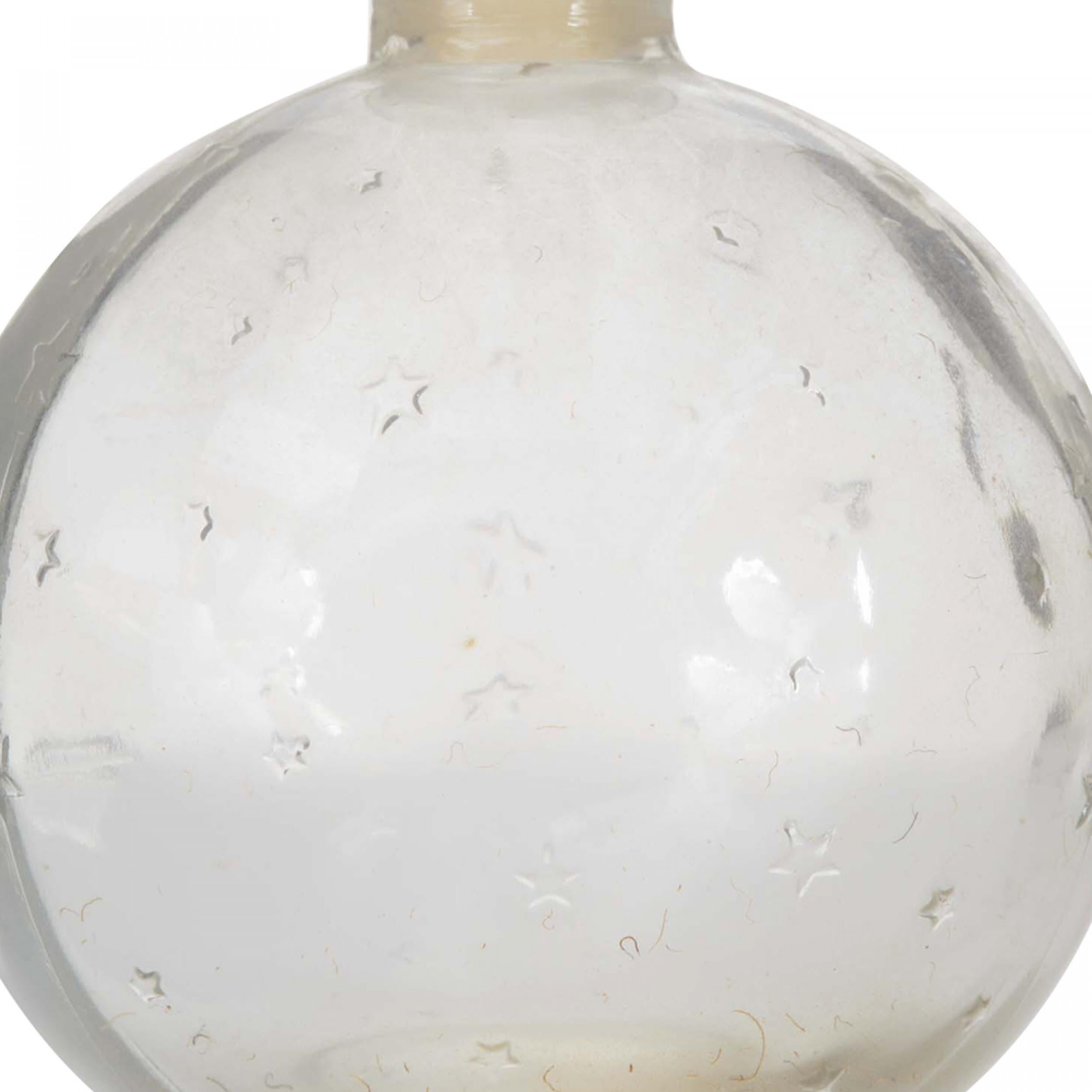 Flacon de parfum en verre Art Déco en forme de boule avec un motif d'étoiles en relief et un bouchon rond plat en verre gravé de la lettre W (signé LALIQUE pour Worth).