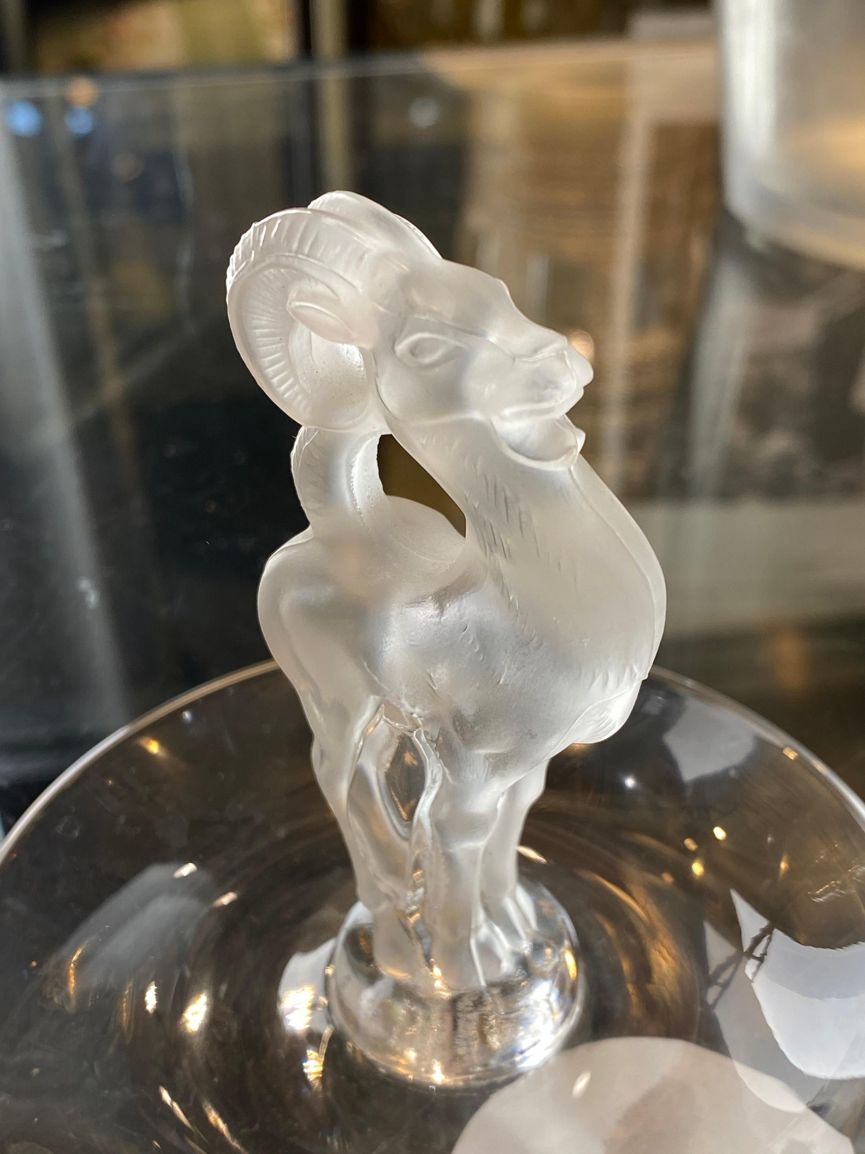 Clear glass small dish form with a antilope figure rising from the center of the Lalique ashtray
Lalique France: engraved signature.