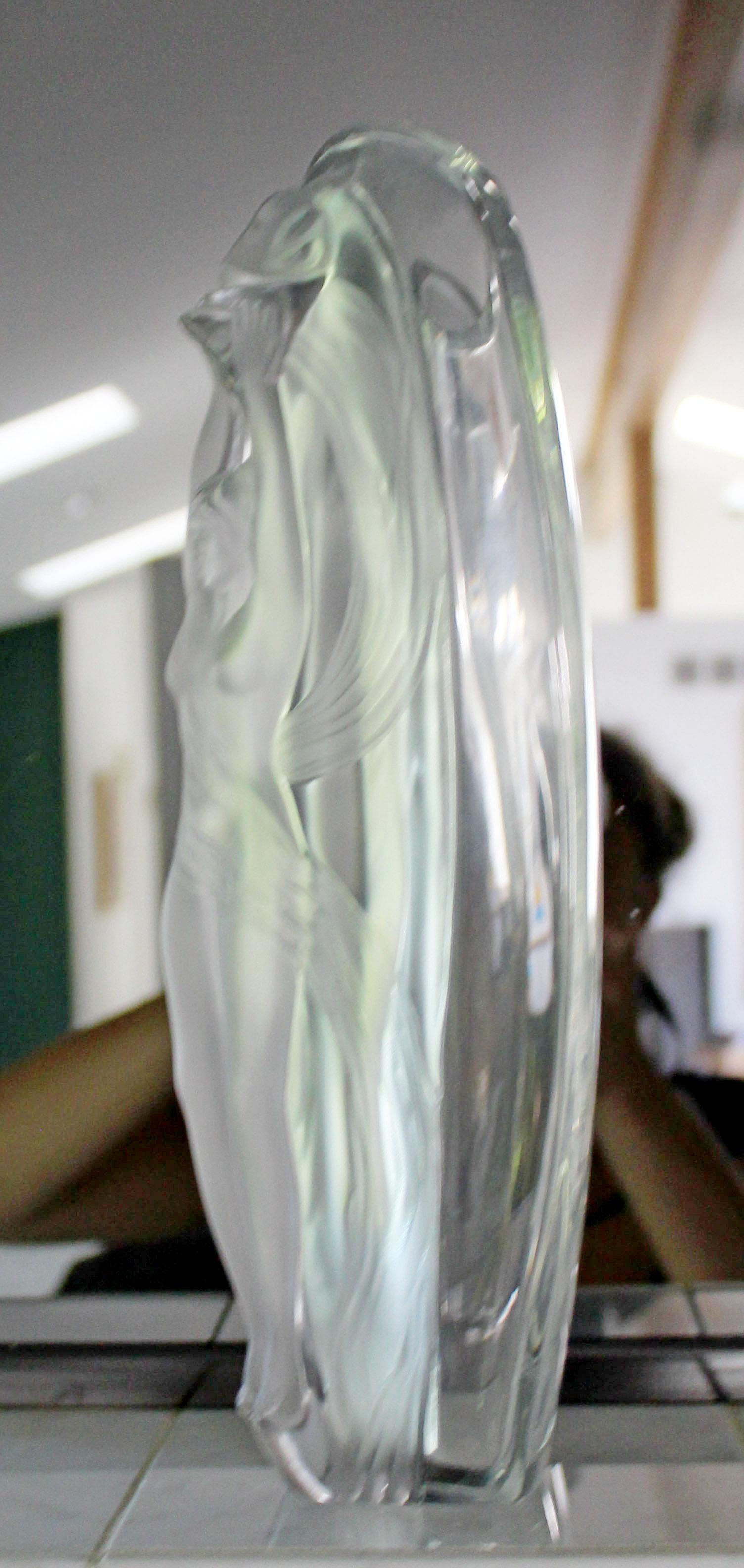 For your consideration is a stunning, glass vase, with a nude woman who is holding a torch on the front, by Lalique France. In excellent condition. The dimensions are 5.5