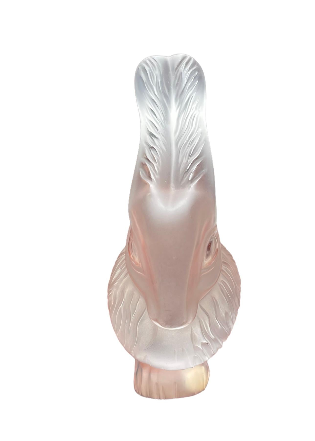 This is a Lalique frosted and clear crystal rabbit “Cesar” figurine. The rabbit is lying down with its straight up ears in alert position and very large expressive eyes. It’s body is covered with a lot of hair. Below the back of its body is the acid