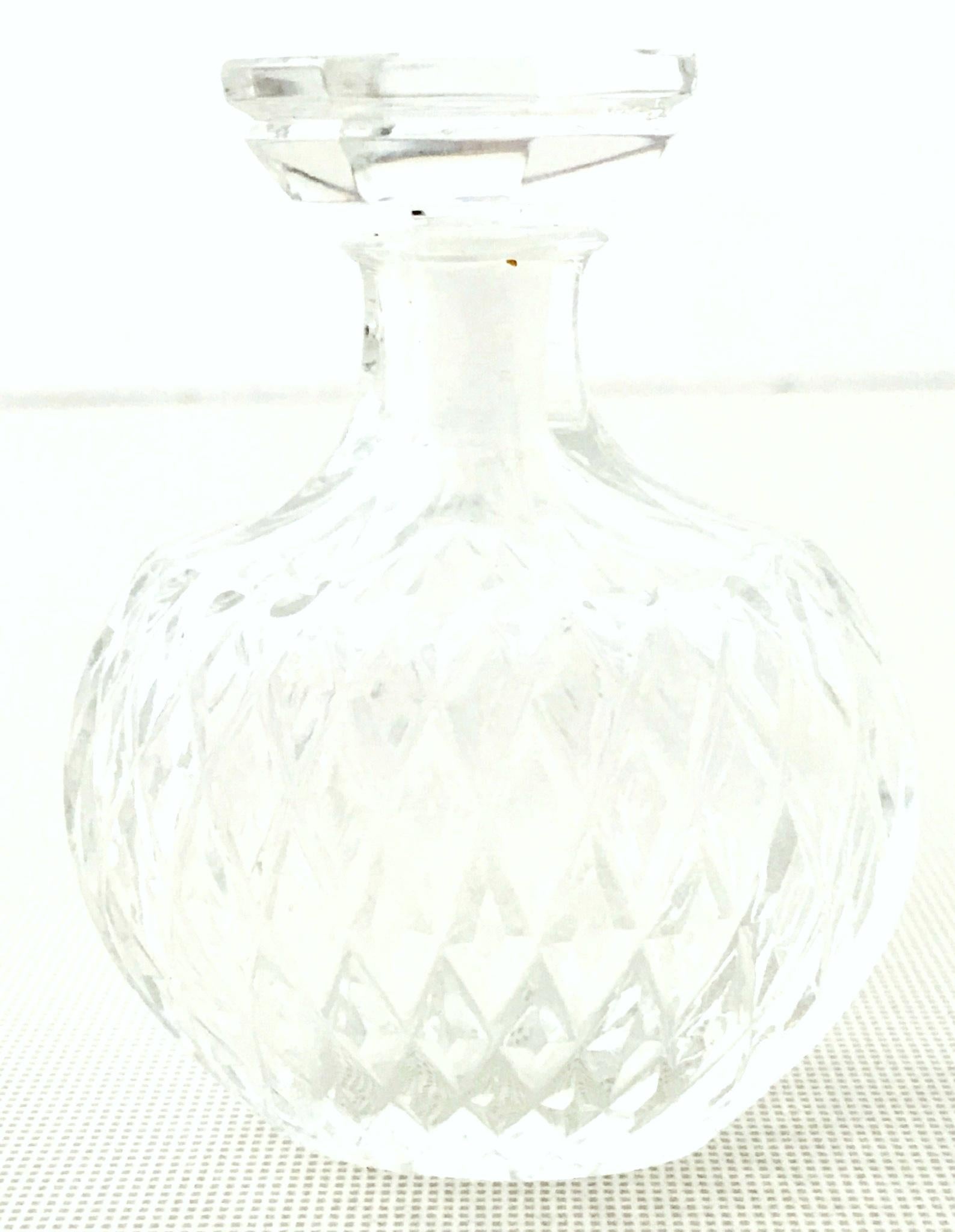 Lalique France cut crystal perfume decanter for Nina Ricci-Signed. This diminutive two-piece Lalique cut crystal decanter features a diamond cut pattern with octagon shaped stopper.
Signed on the underside, Lalique-Made in France, Nina Ricci.