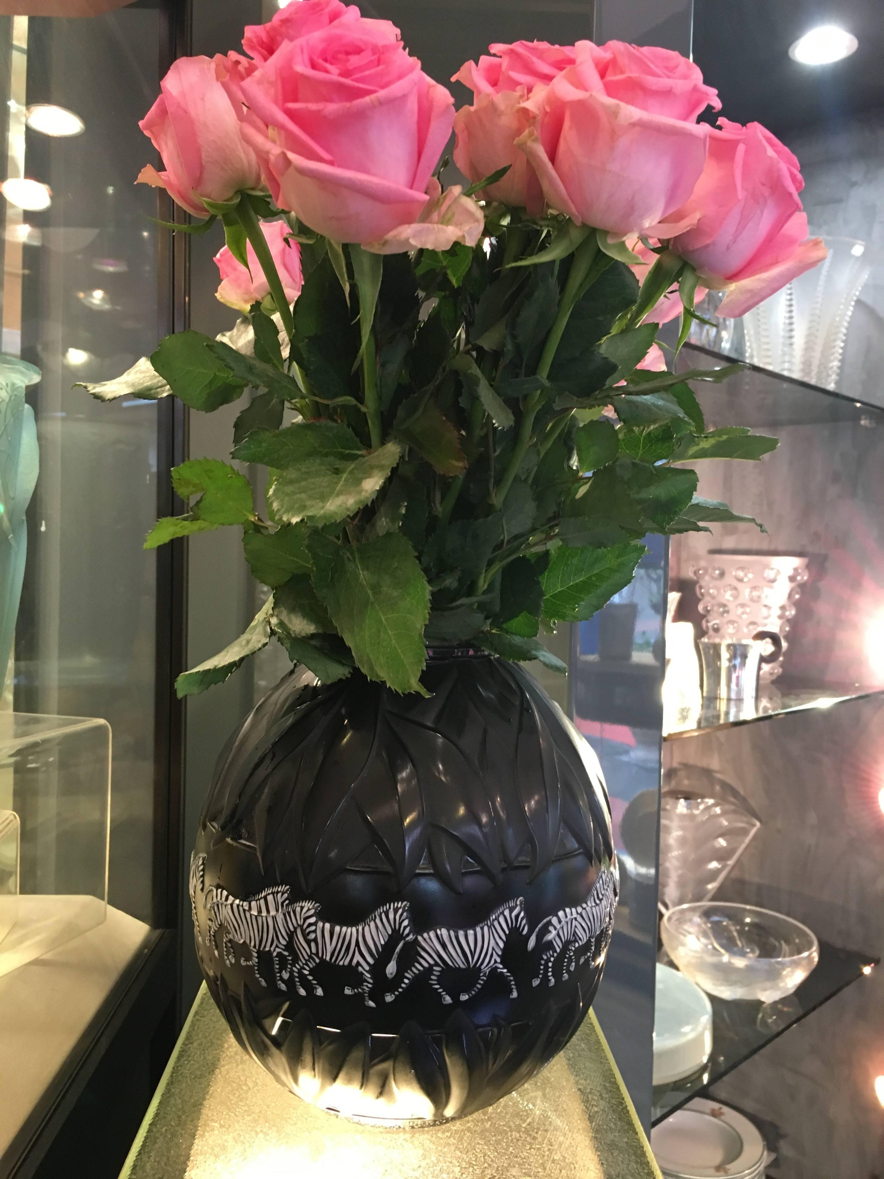 Lalique, France.
A Lalique black moulded glass Tanzania zebra vase, etched Lalique, France 174, modern
Inspired by the elaborate techniques of her grandfather, Marie-Claude Lalique has created a long, slender-necked vase in black crystal. This