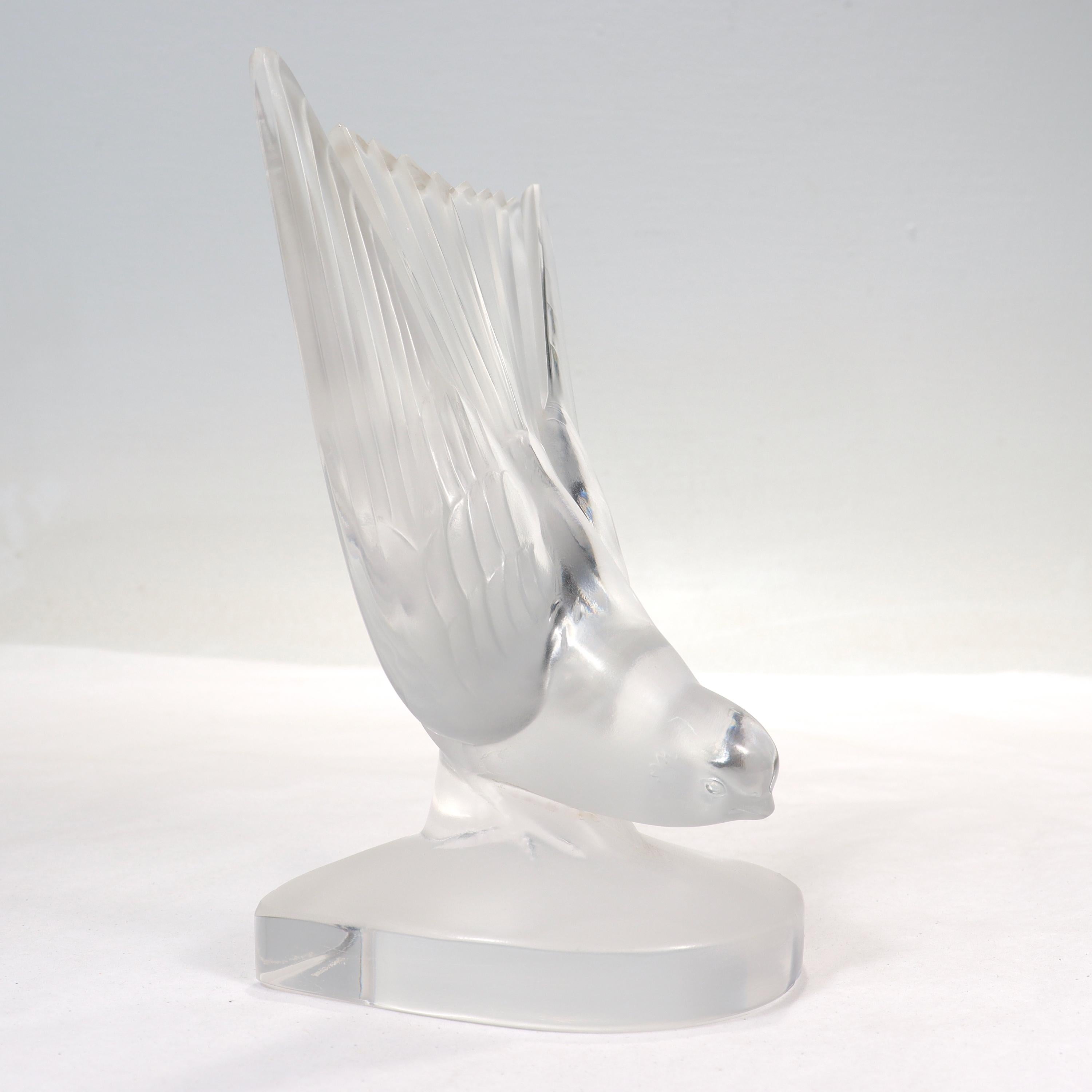 A fine French art glass bookend or paperweight.

By Lalique. 

In the form of a diving swallow bird.

Etched to the base with a 'Lalique France' mark.

Simply a lovely piece of glass from Lalique!

Date:
20th Century

Overall Condition:
They are in