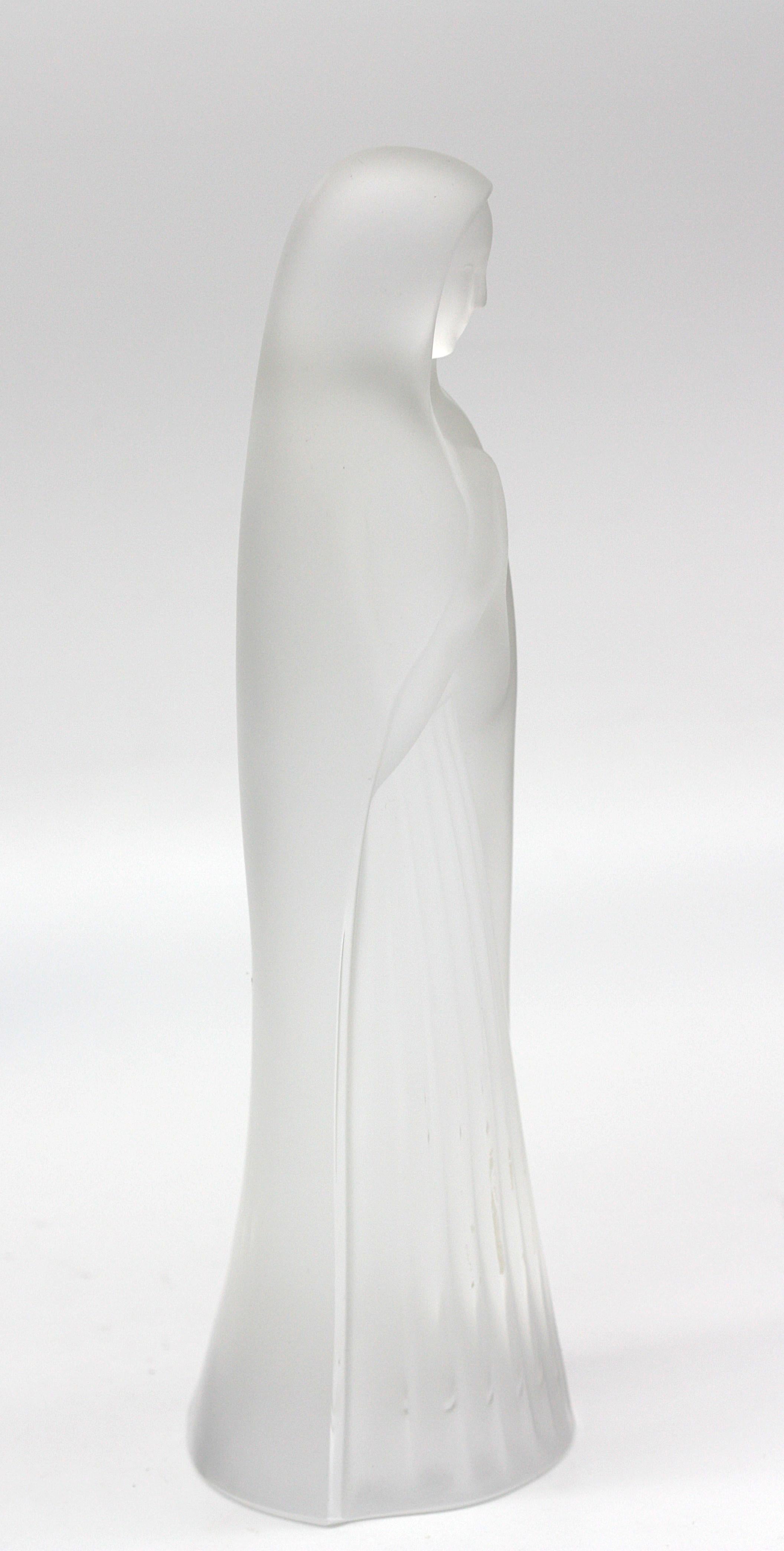 
Lalique Frosted Glass Figure of a Madonna
The underside with etched Lalique France signature. The standing figure with arms clasped in prayer.
Height 9.5 in. (24.13 cm.).