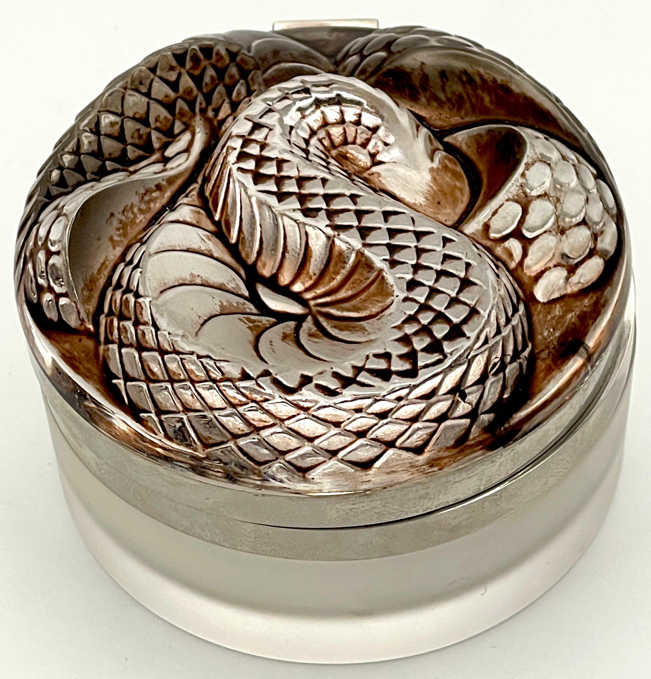 Lalique Gray/Black Serpent Box, 1970s 
France, 20th Century 

A  rare and exquisite Lalique Gray/Black Serpent Box, made in France during the 1970s. Also known as the 'Snake' pattern, this three-dimensional lid features intricately intertwined