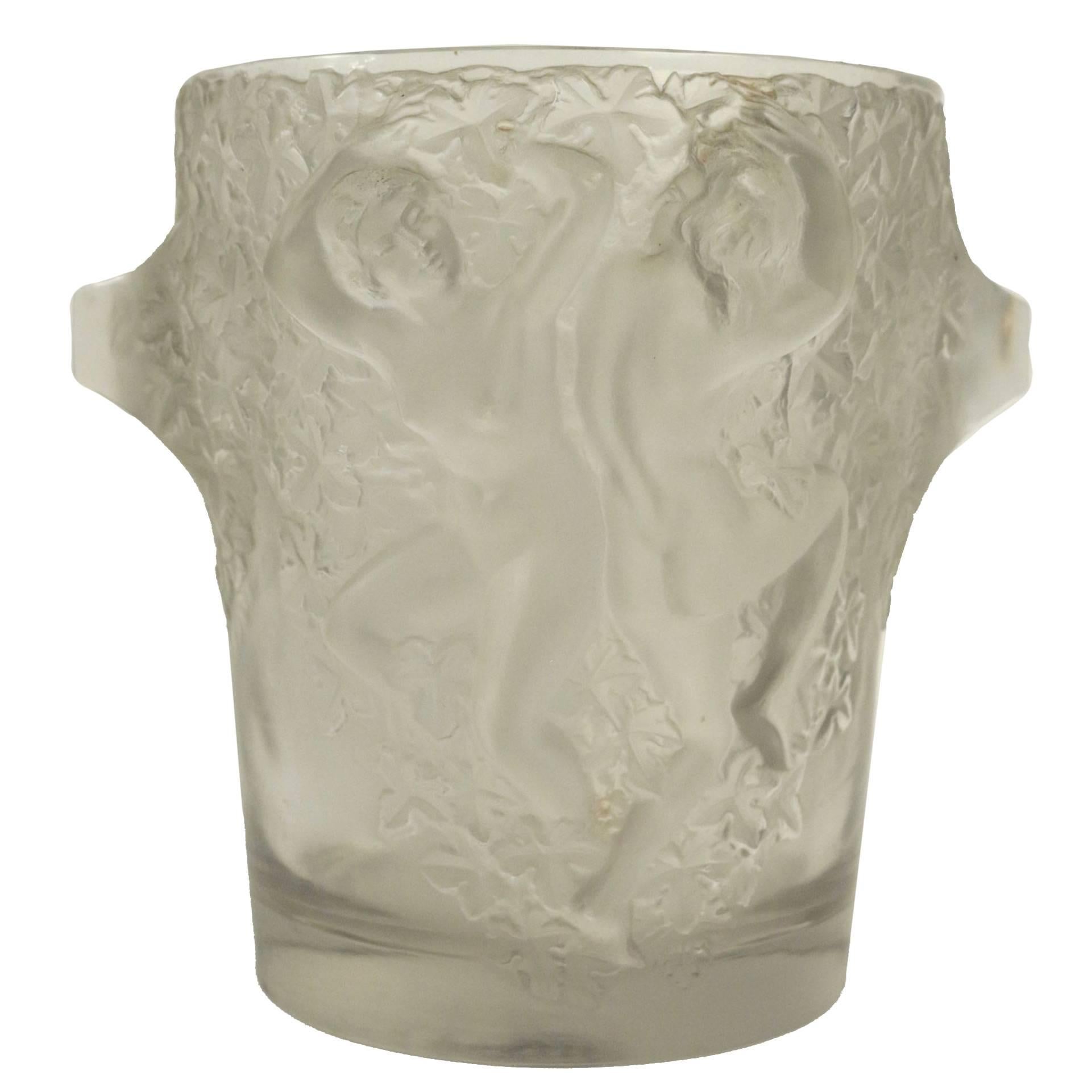 Lalique ice bucket depicting dancing female figures in high relief, circa 1938 design no. 11951. This piece is a perfect example of Lalique's Classic quest for elegant simplicity.
Signed Lalique France on bottom. Measures: 9 1/8