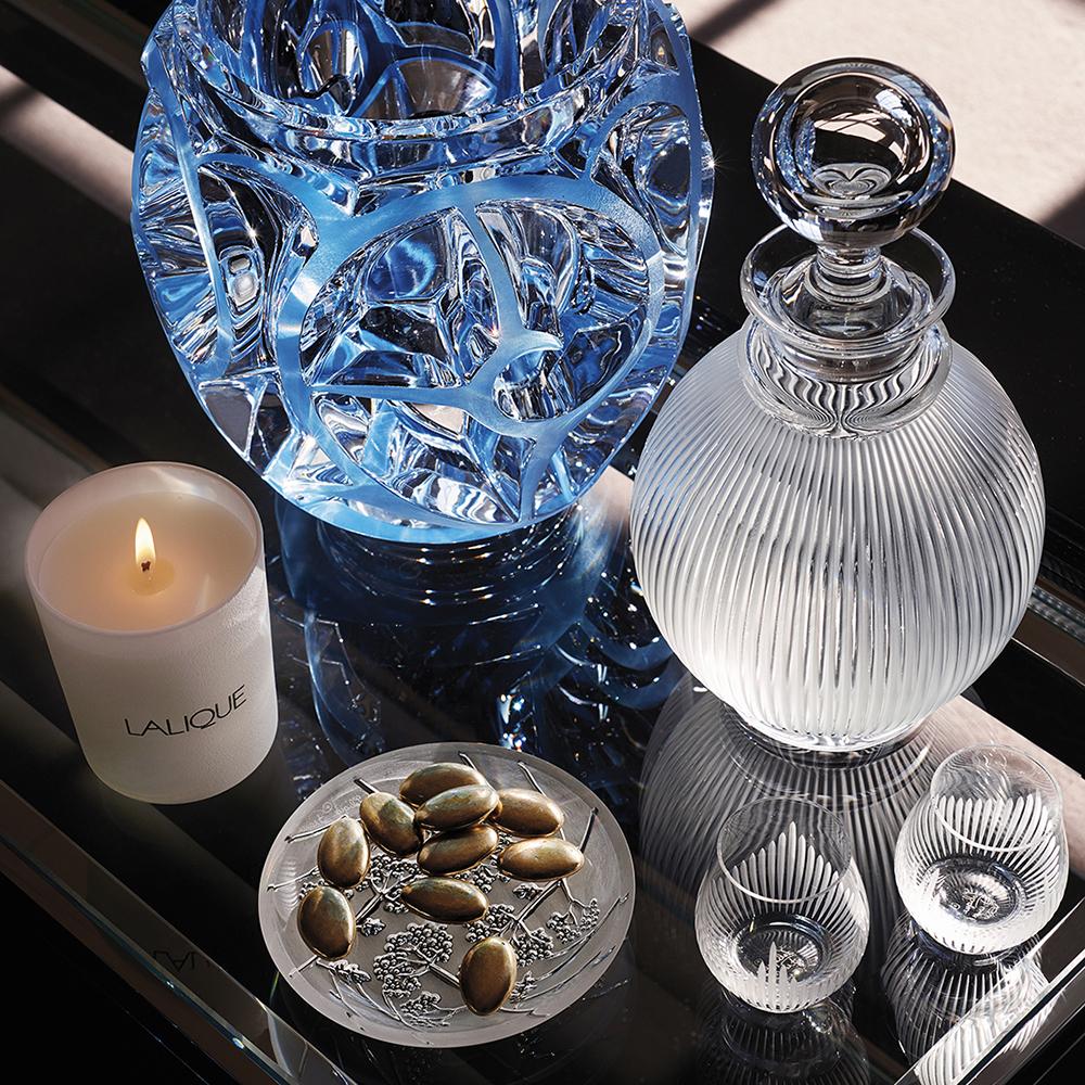 The glass was designed in 1976 by René’s son Marc Lalique, and has become recognized as an iconic pattern. Referencing both fluted antique columns and modernist architecture, it takes seven glass masters to create this glass using the time-honored